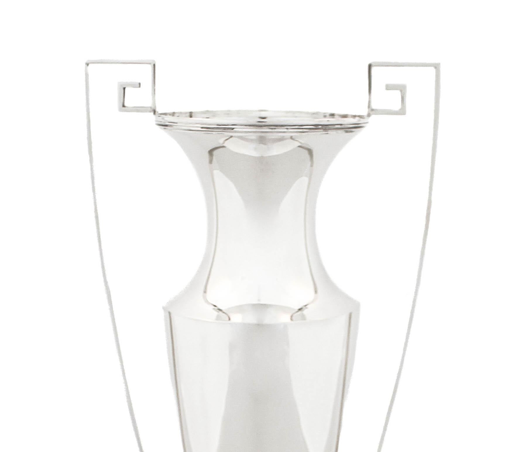 Being offered is a sterling silver vase by Marcus & Company in the “Etruscan” pattern.  It has a tapered shape with with a curved neck.  On each side there are handles in the Etruscan key shape going from the very top until the base.  Uber sleek and
