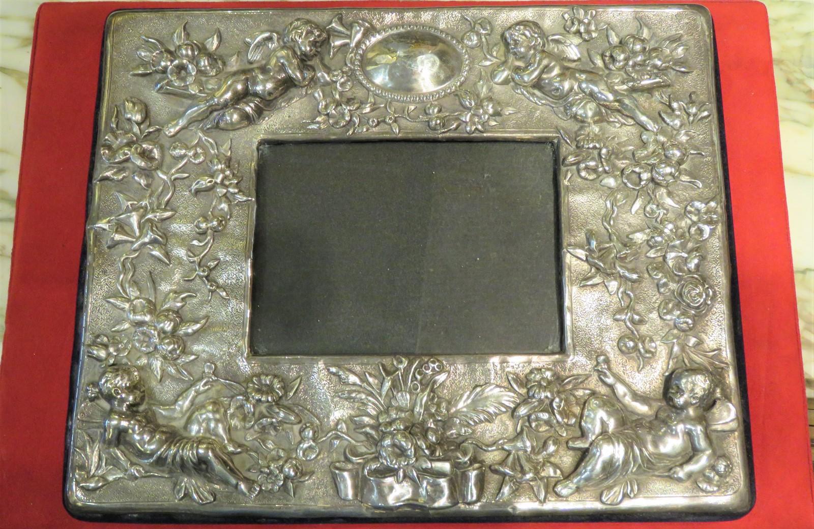 The Following Item we are offering is a Beautiful European Estate Rococo Sterling Picture Frame with Hand Hammered Embossed Cherubs holding Wreaths of Garland and Floral Motifs. Signed Sterling 925. Taken out of a Several Million Dollar NYC Estate