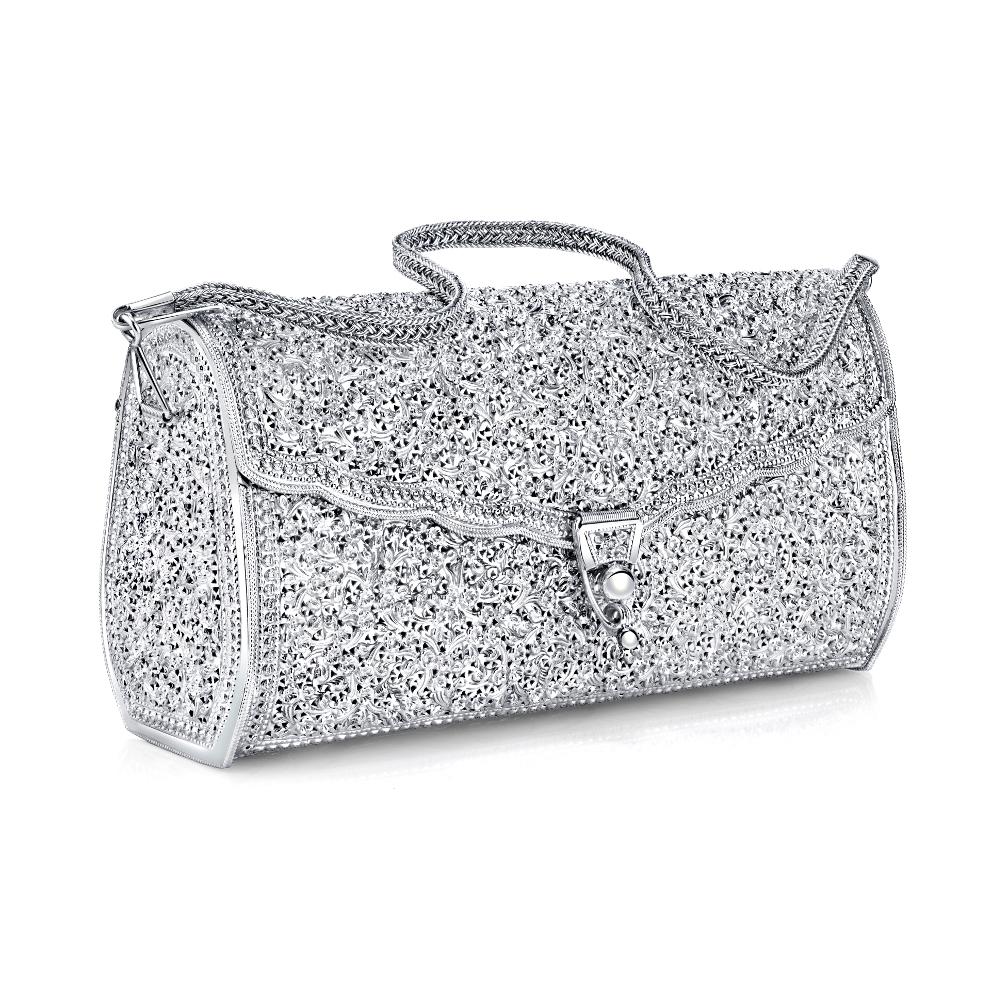 So pretty and unusual! This handmade silver purse is truly a work of art. It is hinged and has a removable woven silver strap, so that it can be worn either as a hand bag or a clutch. It is quite large, measuring 8-1/2 inches in length, 4-1/2 inches