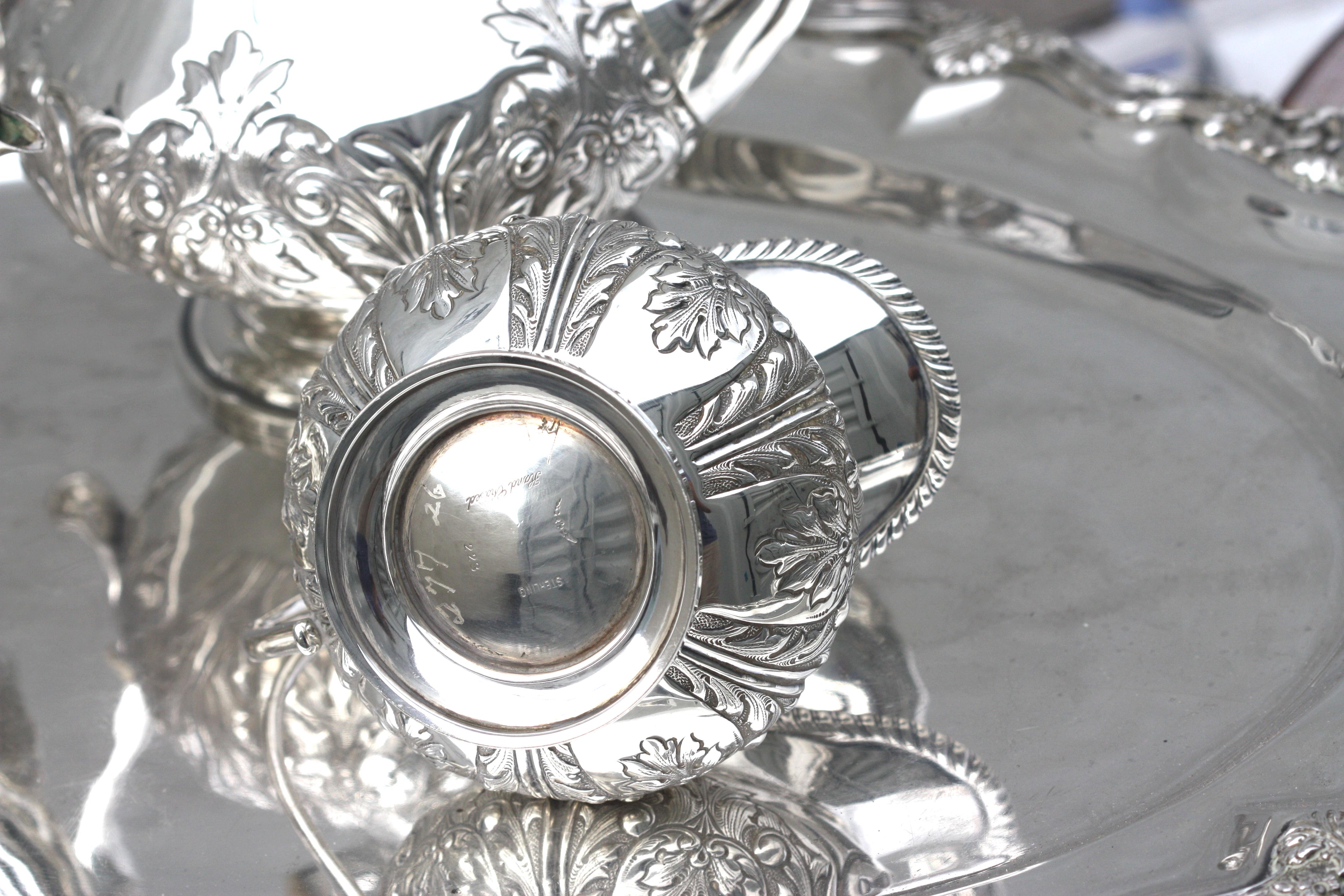 
Sterling Silver Five-Piece Tea Service with Sterling Tray, Mexican. 
The underside marked Sterling, 223, and with an unidentified maker mark of leaves and a flowerhead, with a pattern name Grand Chased. The tray also marked, Mexico Sterling. 
Each