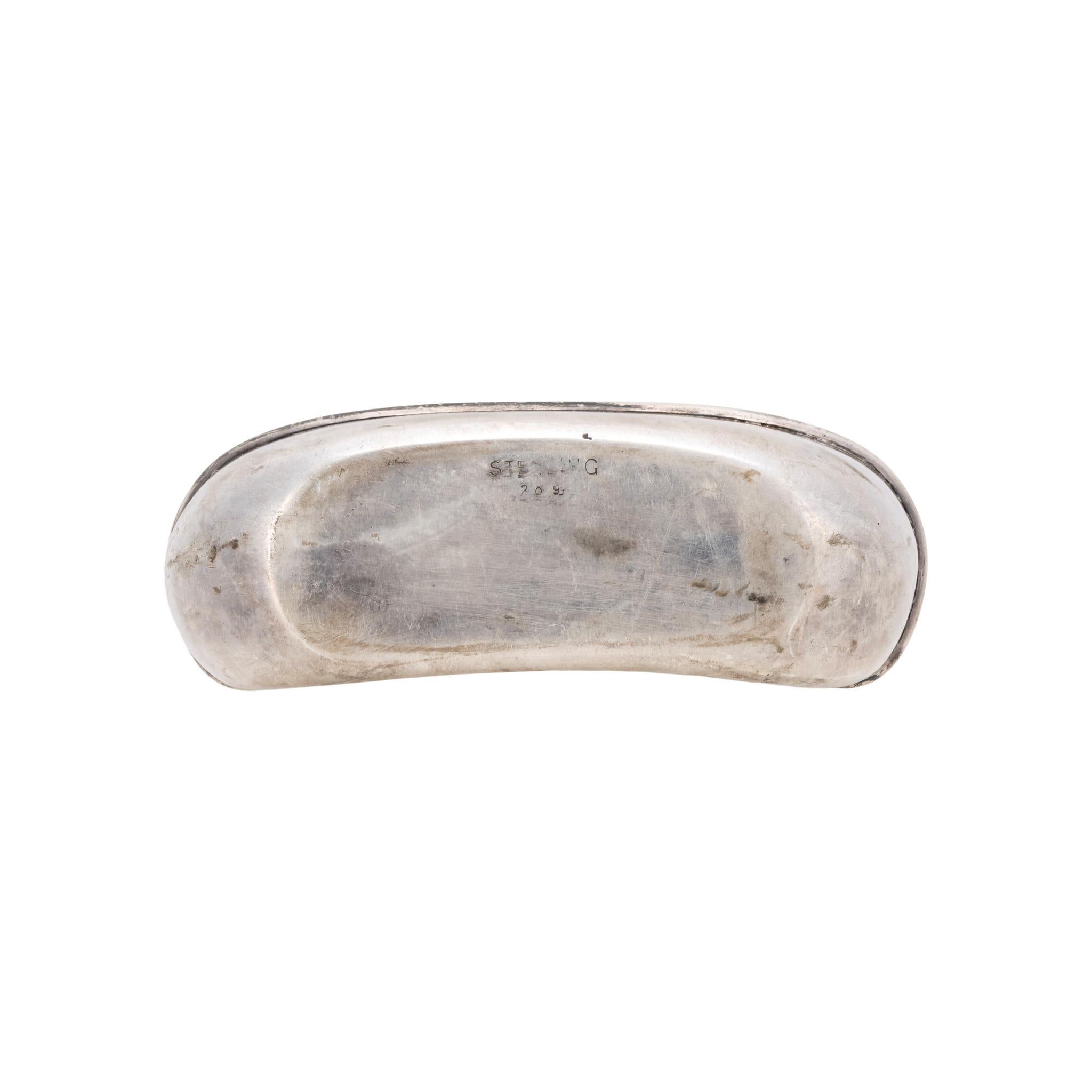 Sterling silver pocket flask. Concave with removable drinking cup. Sterling filigree over glass with connected twist cap lid in working condition. Marked sterling. Beautiful piece, great for continued use or display. Early 20th century. Size: 5