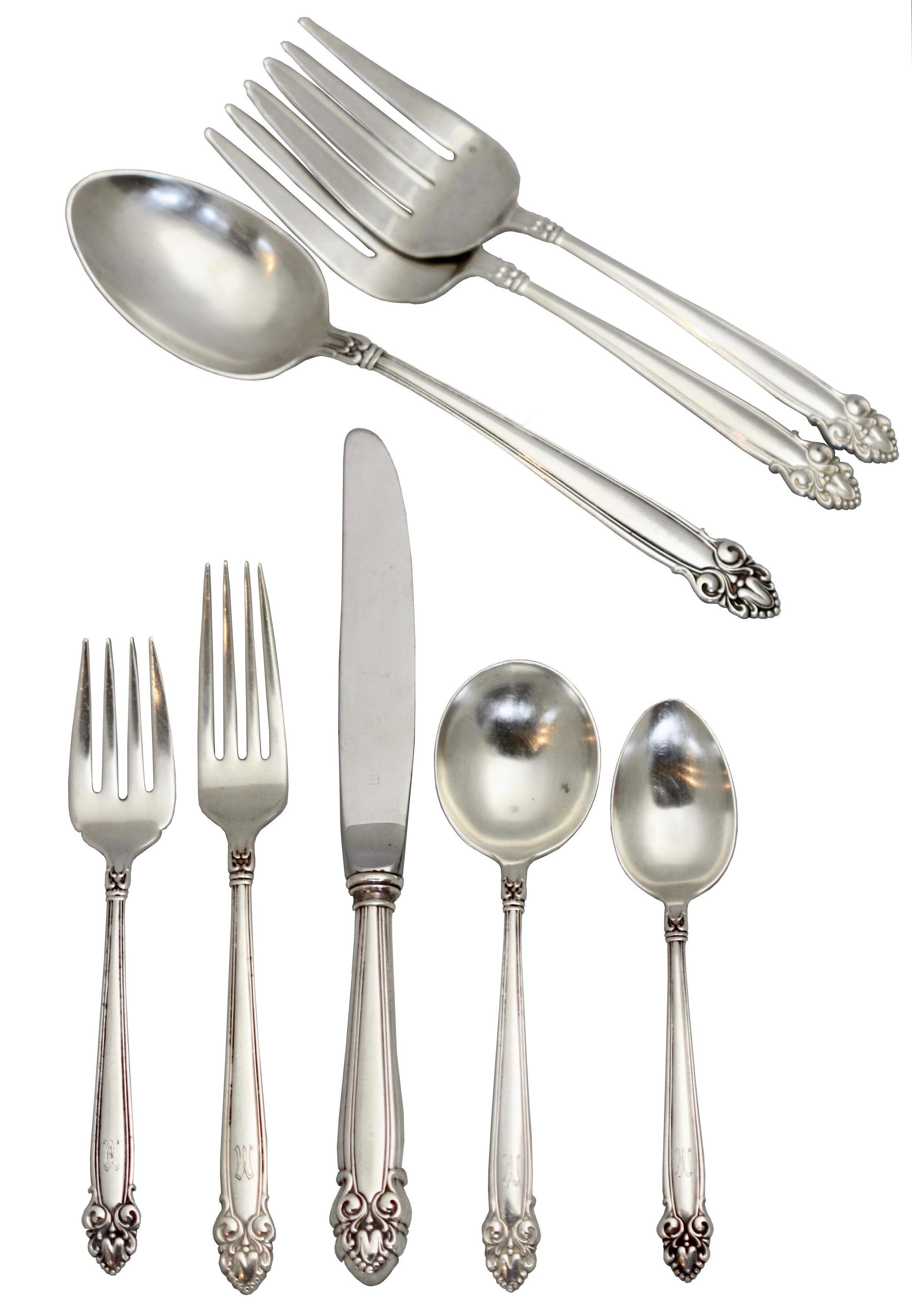 Sterling silver flatware set by Lunt 
consisting of: 
6 dinner knives (8 7/8 in.)
7 dinner forks (7 1/4 in.)
7 salad forks (6 3/8 in.)
8 round soup spoons (6 1/4 in.)
7 teaspoons (5 3/4 in.)
1 serving spoon (8 1/4 in.)
2 serving forks (7 1/2
