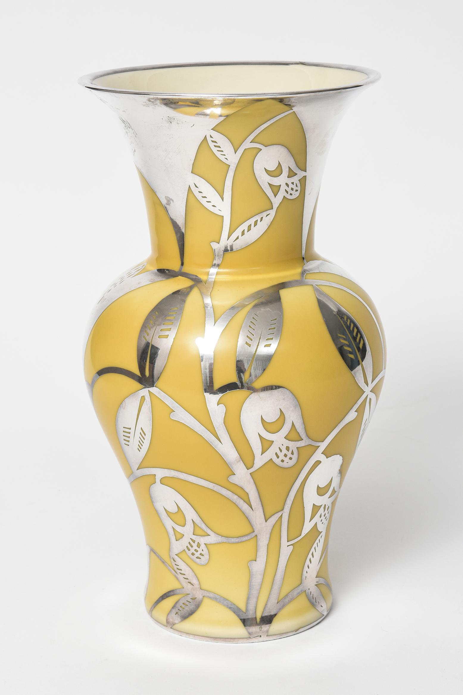 Mid 20th century sterling silver overlay featuring flowers, vines and leaves on a yellow porcelain vase. The vase was produced by Thomas Bavaria in the Germany US Zone (1945-1949)

Marked: Thomas Ivory Thomas Bavaria Sheild produced in Germany US