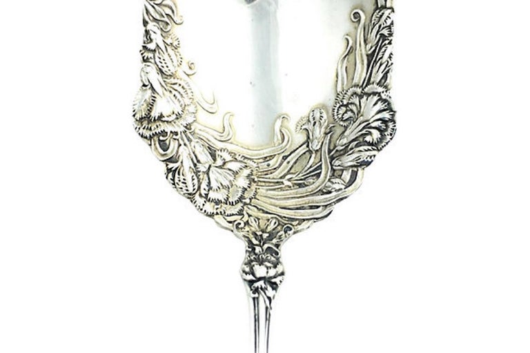 Rare sterling silver ornate floral repousse serving or berry spoon by Simpson, Hall, Miller & Co. Founded in 1866 in Wallingford, Connecticut. They were famous for their incredible repousse work which this piece is a fine example off. They became