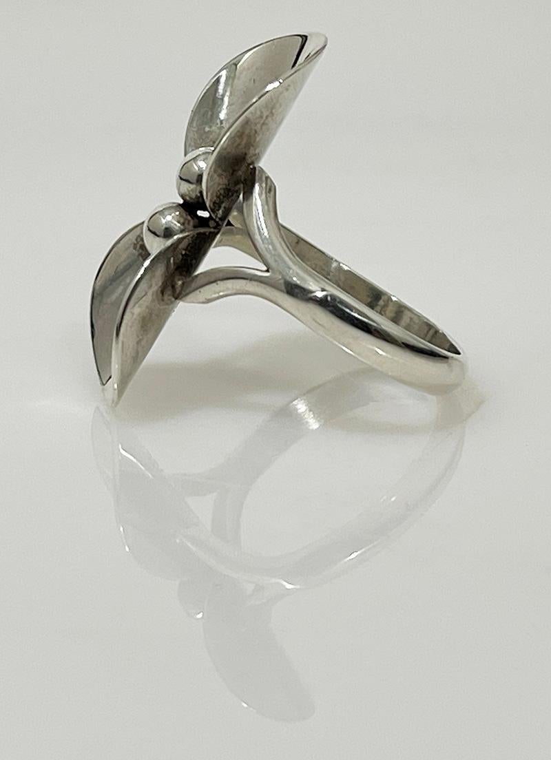 Sterling silver flower ring by Niels Erik From, Denmark, Mid-20th C

A Sterling Silver ring in the shape of a flower, made by the Danish Jewelery Designer Niels Erik From (1908-1986). The Danish silver hall mark is on the back of the leaf of the