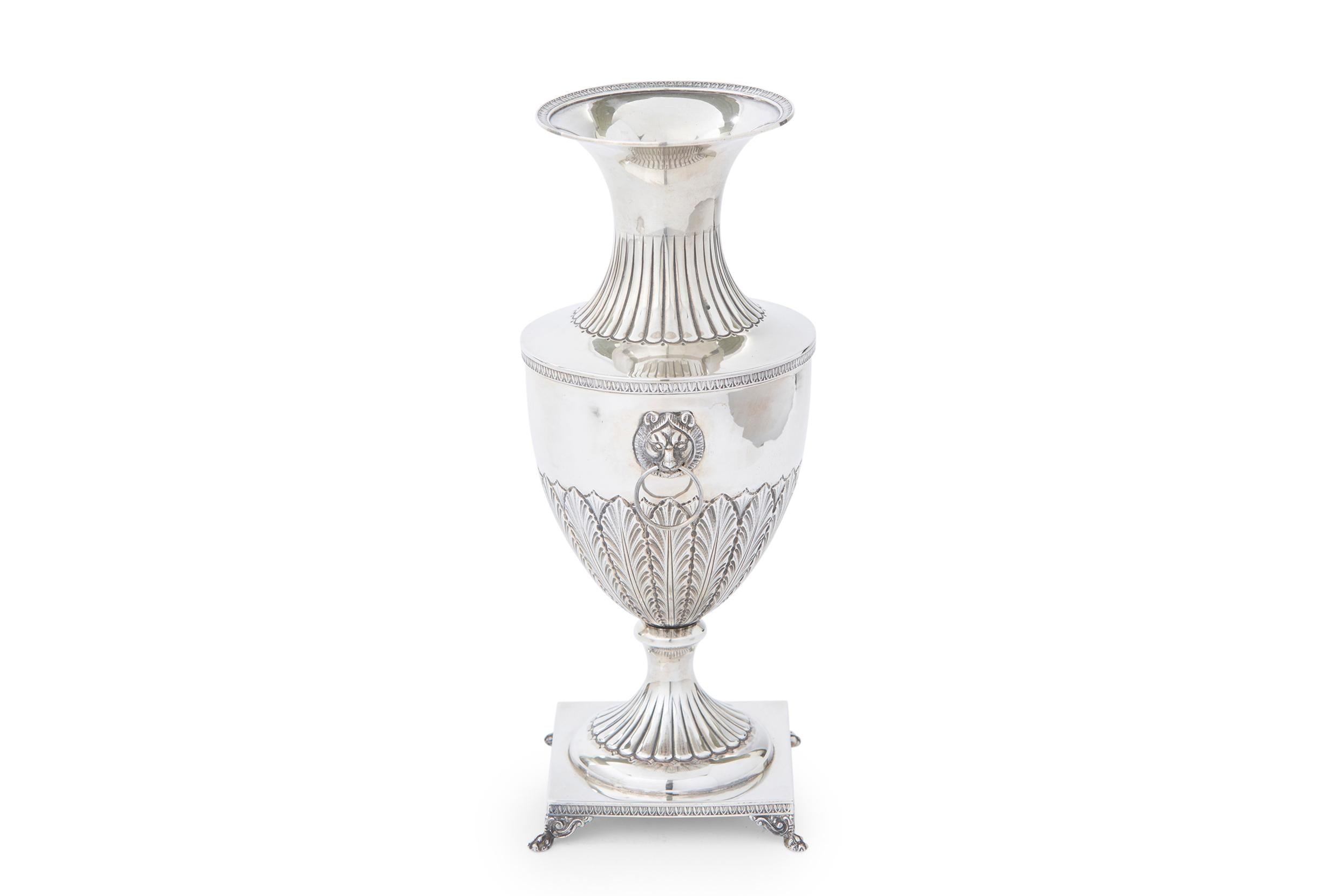 Sterling silver footed decorative vase / piece with Lion heads side handles and exterior design details resting on square footed base. The sterling piece is in great antique condition. Minor wear consistent with age / use. Maker's mark undersigned.