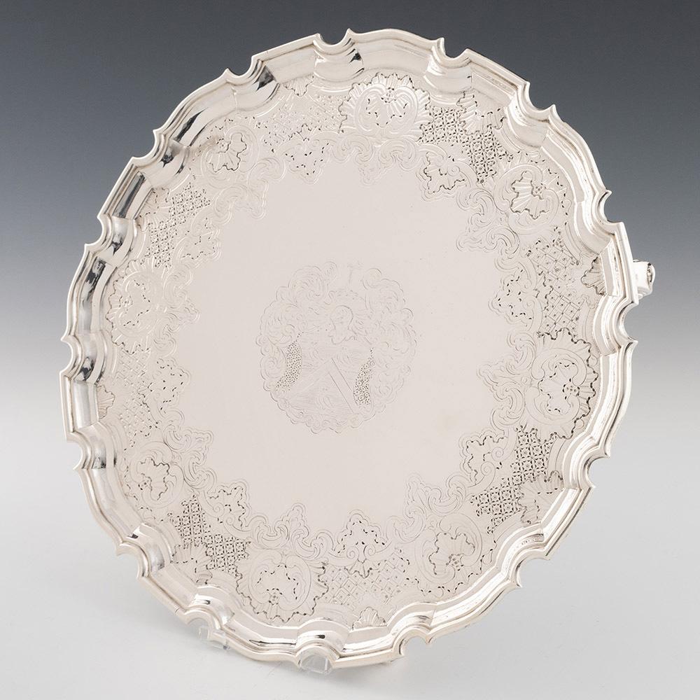 Heading : A Sterling Silver Footed Salver
Date : Hallmarked in London 1735 For William Kidney
Period : George II
Origin : London England
Decoration : Profusely engraved. The coat of arms of the Prescott family surrounded by an elaborate rococo