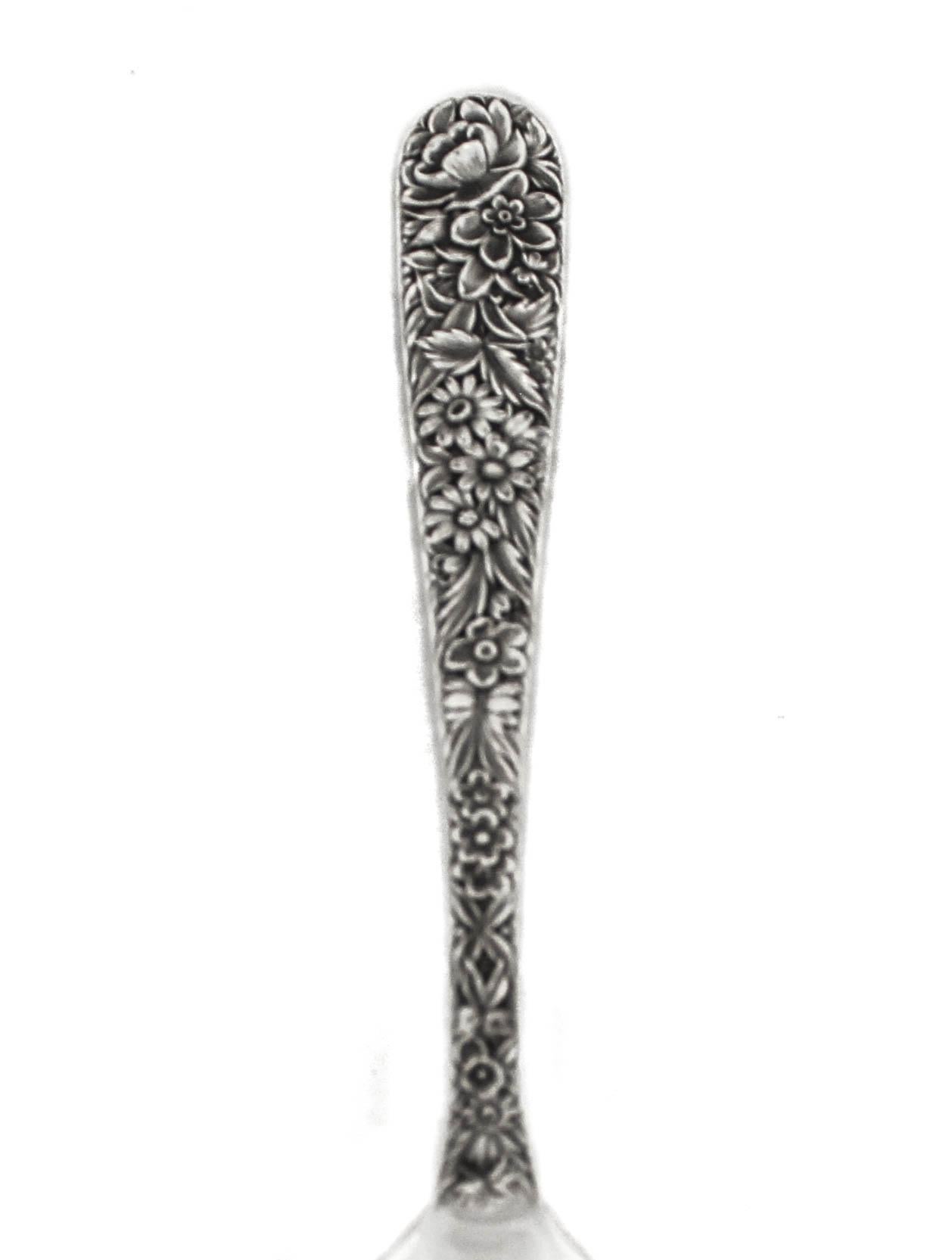 Being offered is a sterling silver serving spoon by S. Kirk and Sons in the “Forget-Me-Not” pattern, 1910.  A gorgeous floral motif of  daises, roses and leaves decorates the entire length of the handle.  The Kirk / Steiff Company of Baltimore was