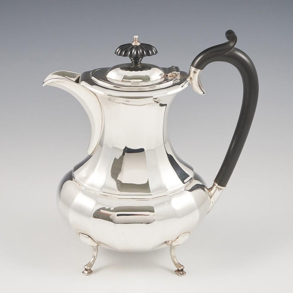 Heading : A four piece sterling silver tea and coffee set.
Date : Hallmarked in Birmingham for J Gloster. The coffee jug in 1925 all other pieces in 1926.
Period : George V.
Origin : Birmingham, England.
Decoration : Queen Anne style