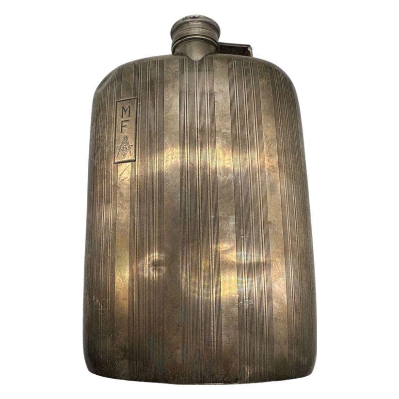 This Antique Liqueur Prohibition Era Free mason Sterling Silver Hip Flask. Curved hip flask featuring alternating etched stripes and a smooth polished finish stripe on the front, a smooth polished finish on the back and a screw top with original