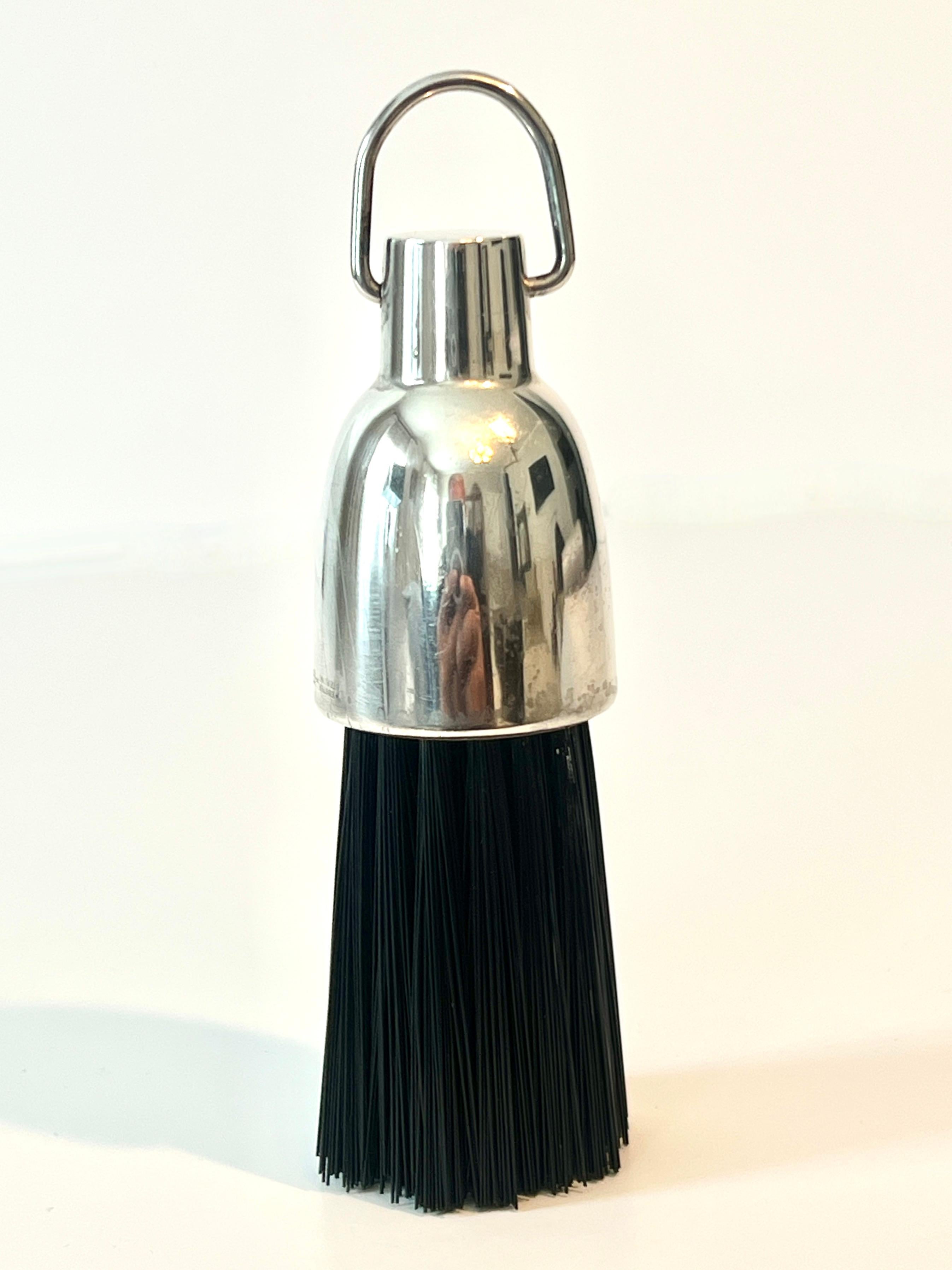 A very sophisticated garment brush great for the jacket, suit coat or pants.. could also be used in any room that needs a small brush.

The top portion is sterling with a ring for holding - looks great on the dressing table or within a series of