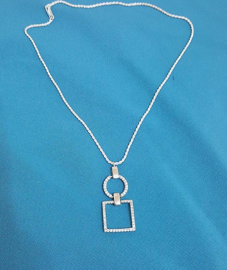 Sterling Silver Geometrics Pendant Necklace, Stamped
This stunning open circle and open square pendant has what we think are tiny CZs in it. The two shapes have a swinging connectors so that the shapes can move.  The chain's connector is stamped and