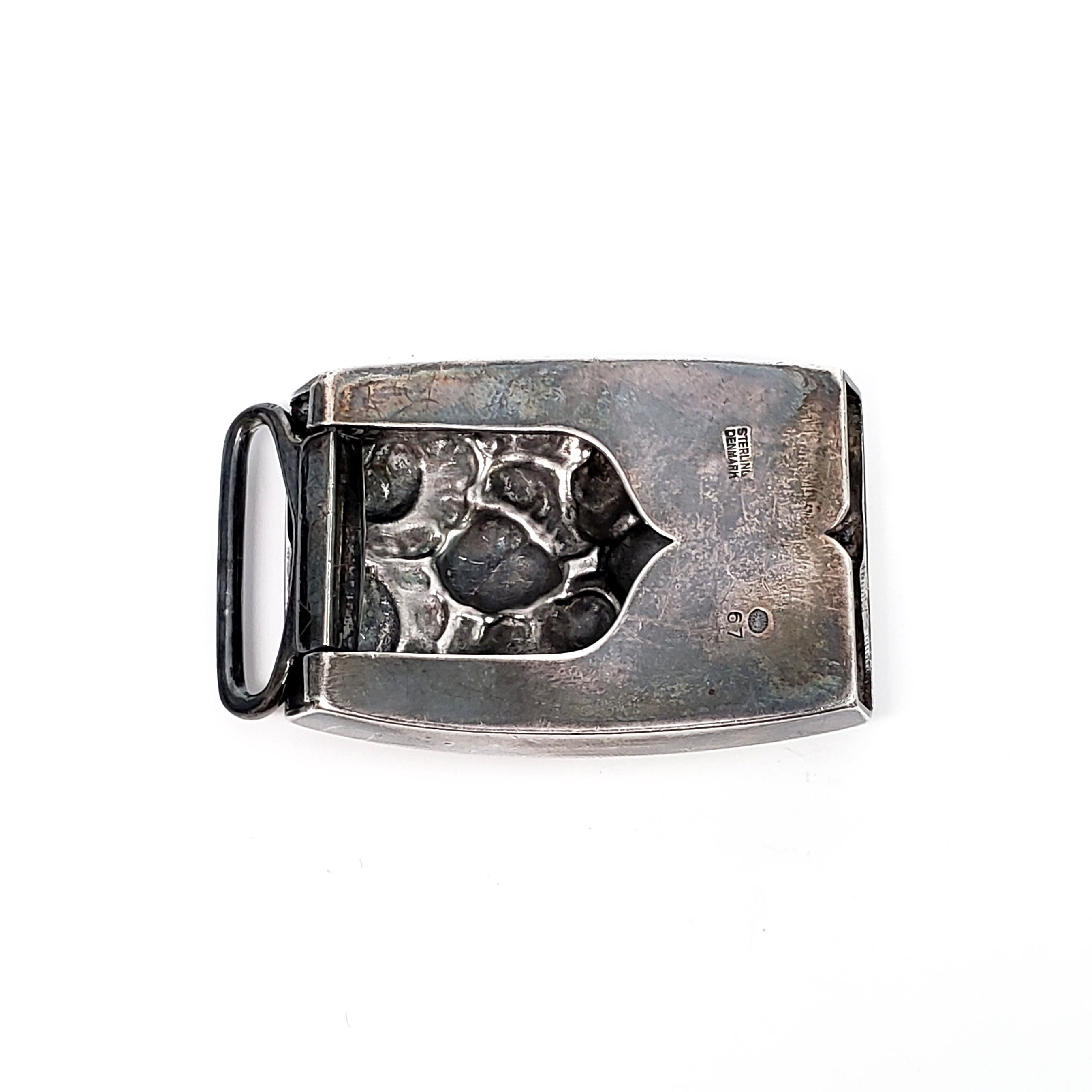 Antique sterling silver belt buckle from Georg Jensen in the Acorn pattern #67, circa 1915-1927.

The Acorn pattern was introduced in 1915 as a collaboration between Georg Jensen and designer Johan Ronde. The pattern combines Art Nouveau and Art
