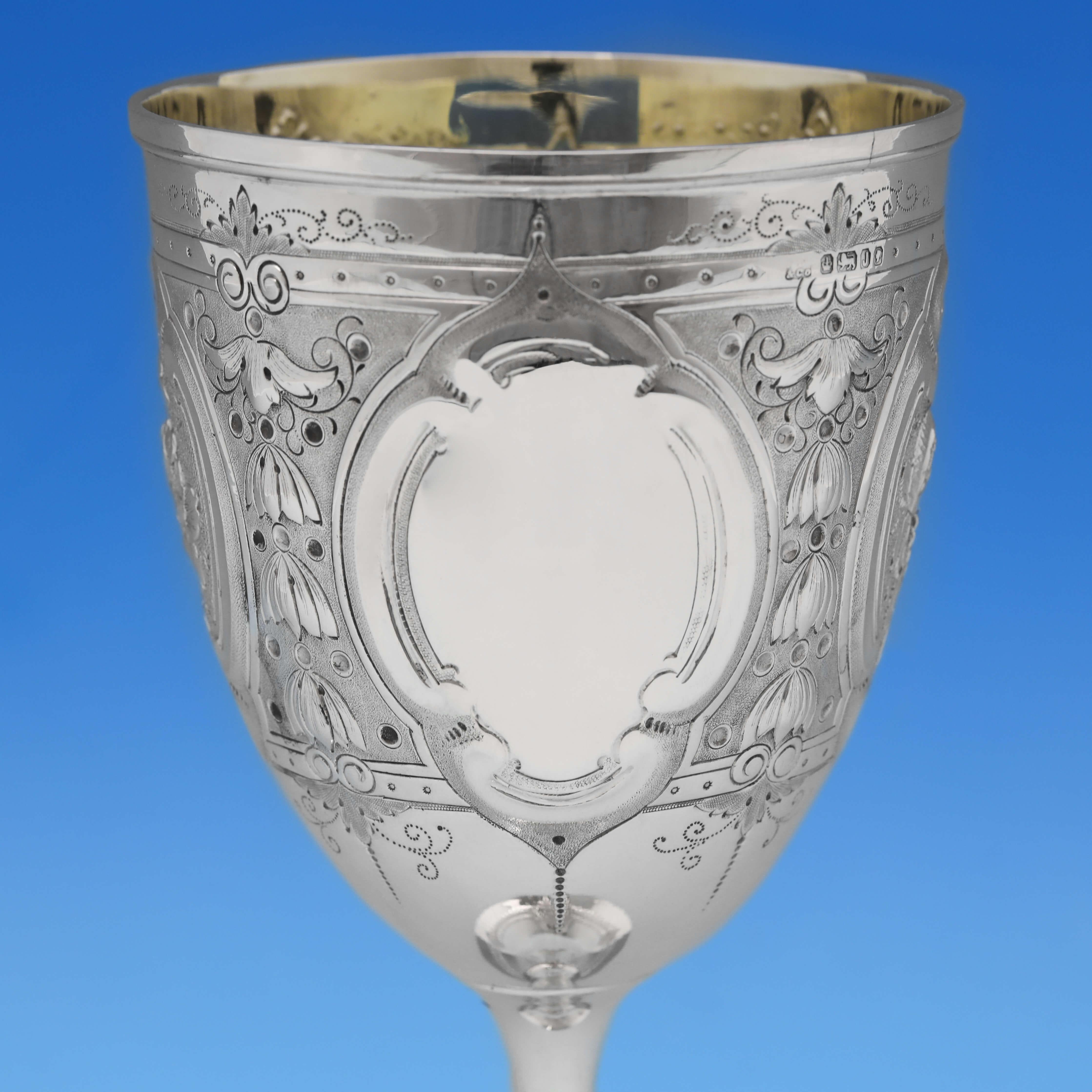 Hallmarked in Sheffield in 1876 by Henry Wilkinson & Co., this striking, Victorian, Antique Sterling Silver Goblet, features wonderful chased and engraved decoration, and a gilt interior. The goblet measures 8.5