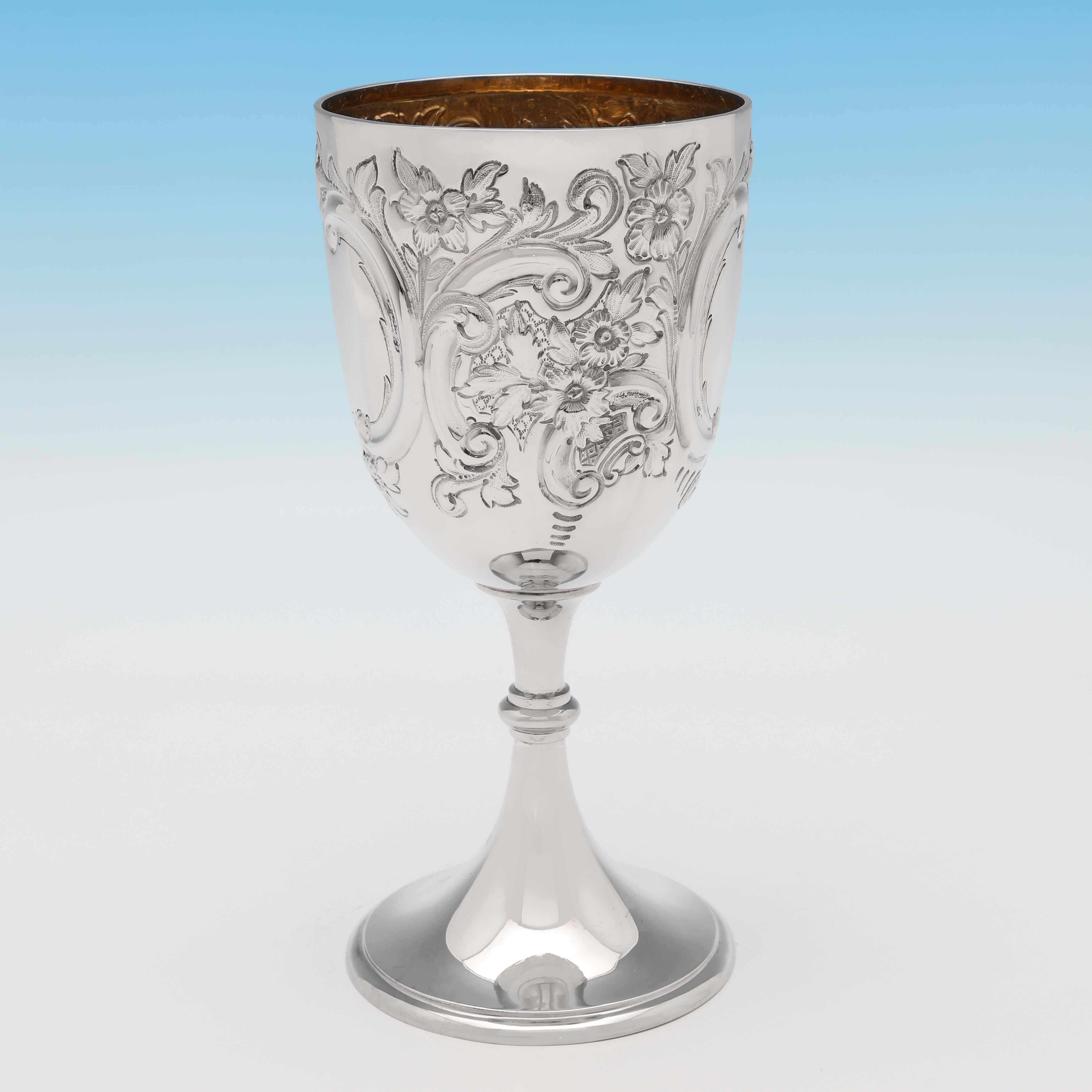 Hallmarked in London in 1891 by Barnards, this attractive, Victorian, Antique Sterling Silver Goblet, features chased decoration to the body and a gilt interior. The goblet measures 8.5