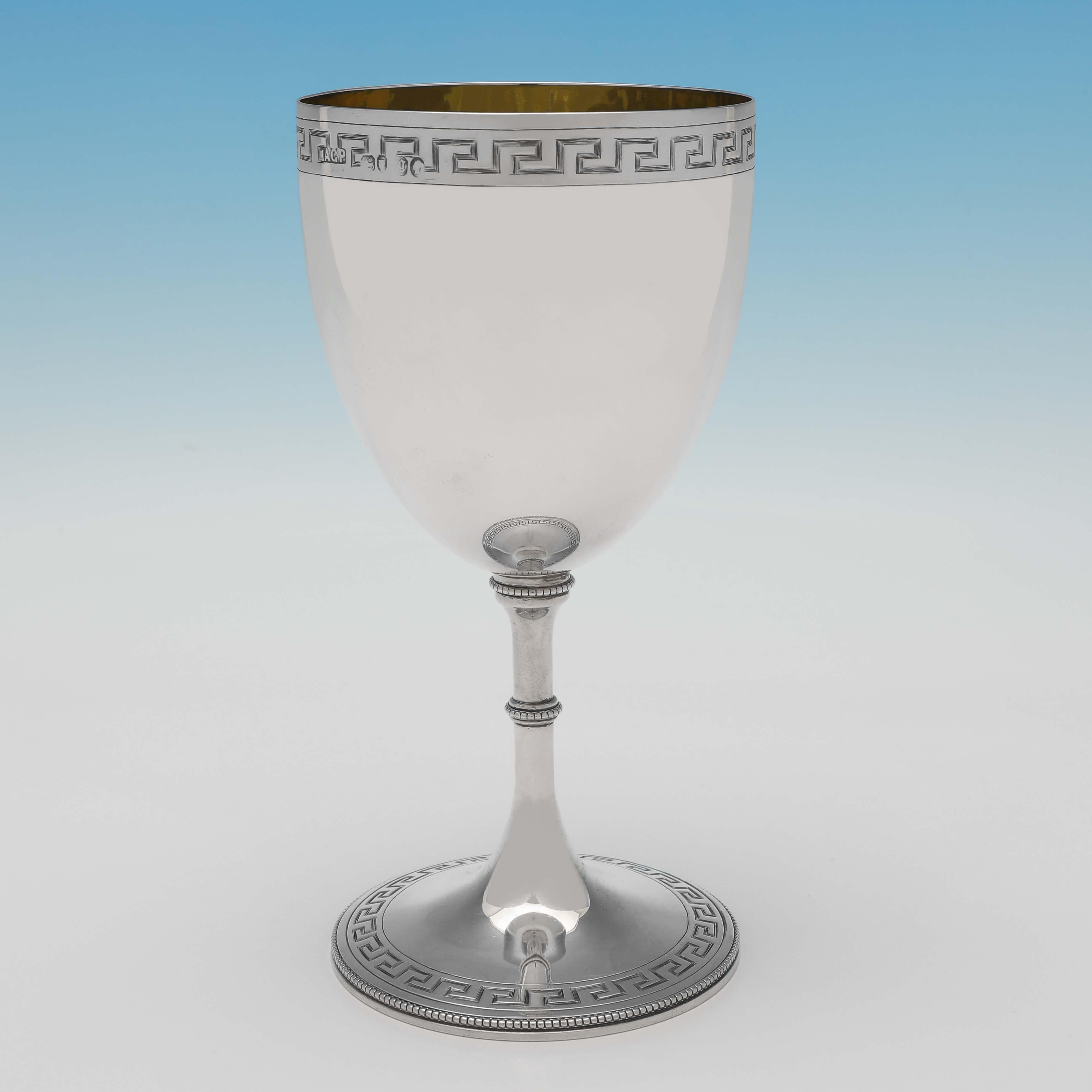 Hallmarked in London in 1862 by Augustus George Piesse, this very attractive, Victorian antique sterling silver goblet, features engraved bands of greek key decoration and an engraved crest and sheild. The goblet measures 7.25