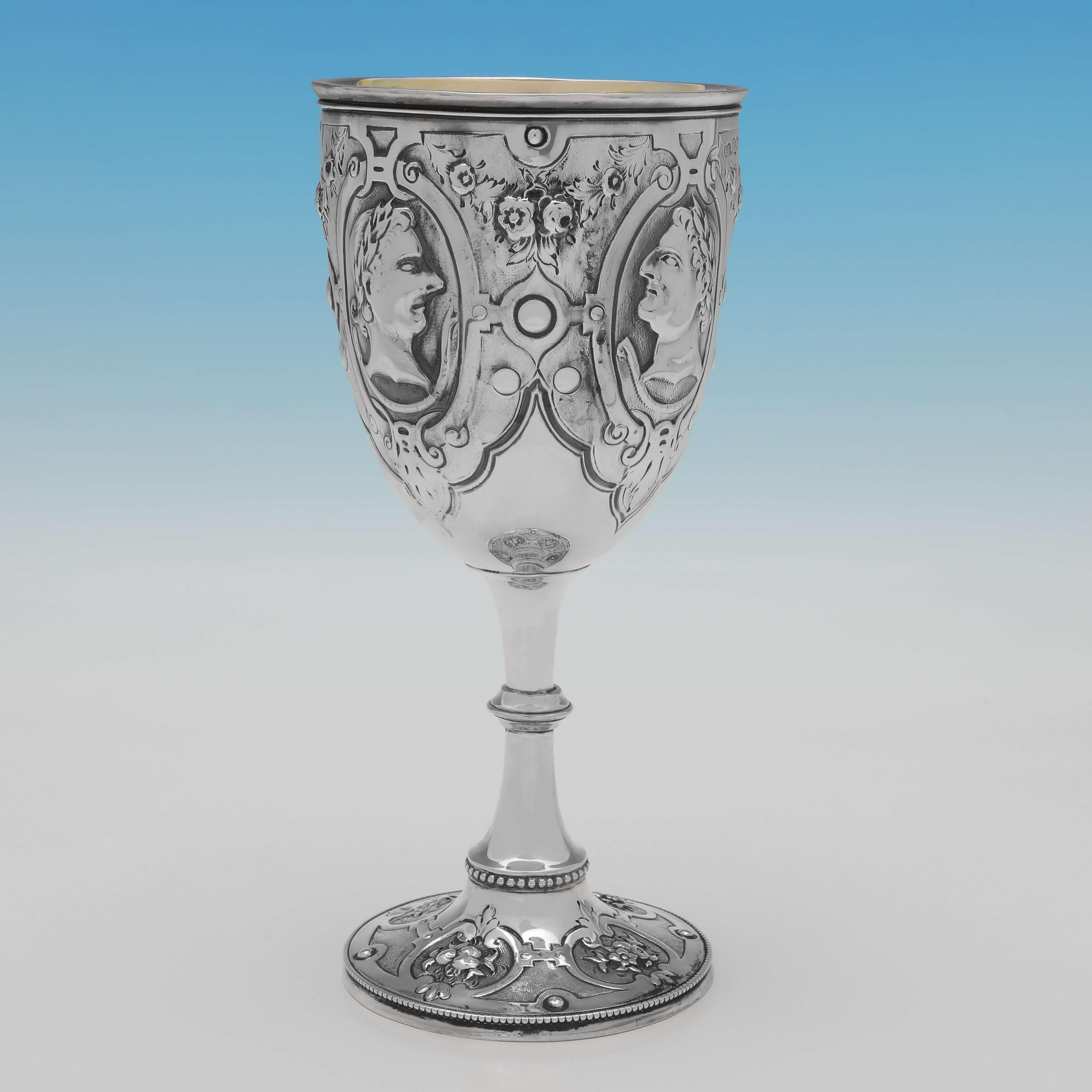 Hallmarked in London in 1874 by Henry Holland, this striking, Victorian, Antique Sterling Silver Goblet, features chased busts of Roman Emperors, a gilt interior, and bead detailing. The goblet measures 8.5