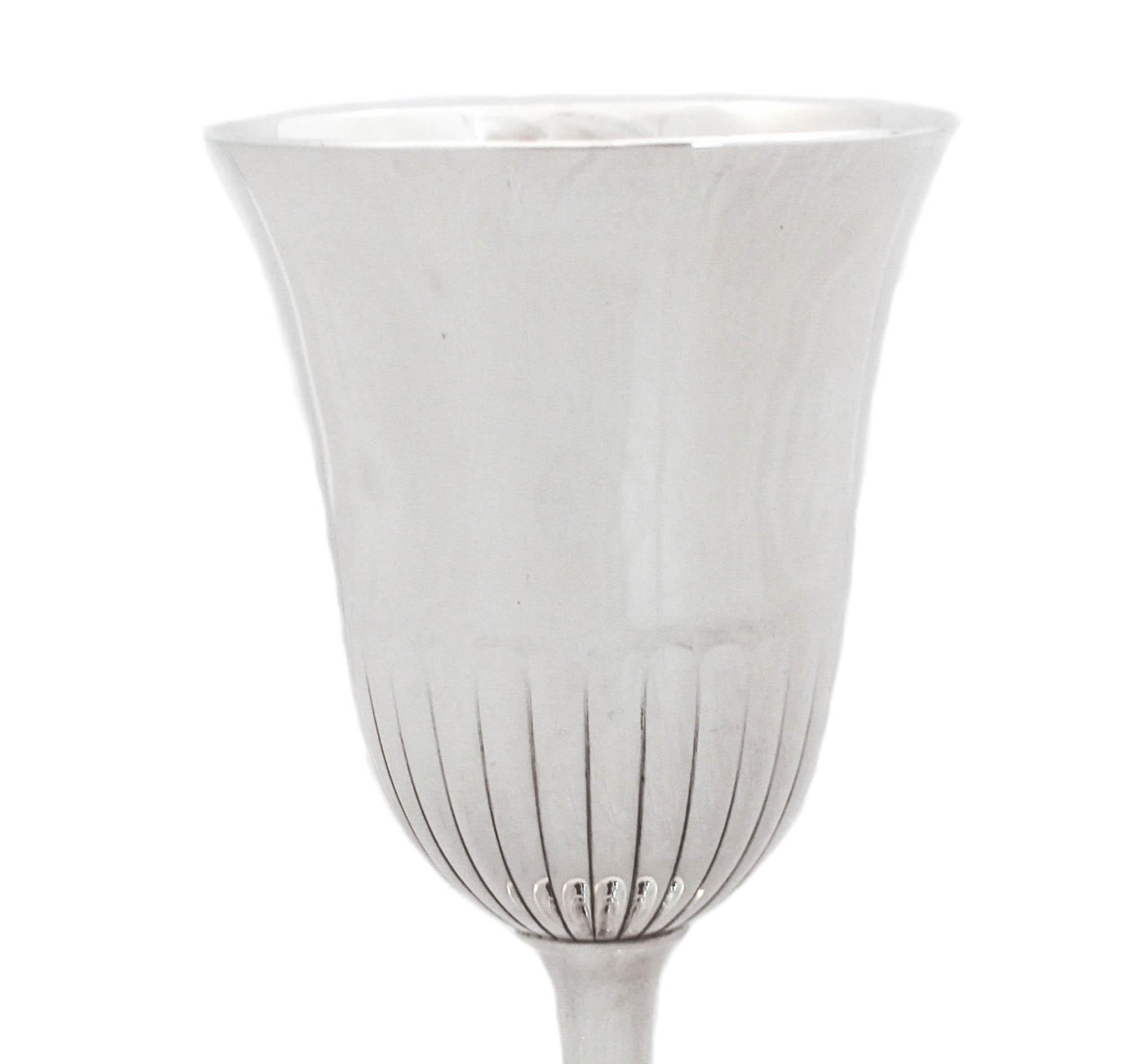 This large sterling silver goblet was made by Wallace Silversmiths. It has a beautiful shape and the base is not weighted. Sleek with a ridge design around the center giving it a some personality. This is a lovely wedding or housewares gift.