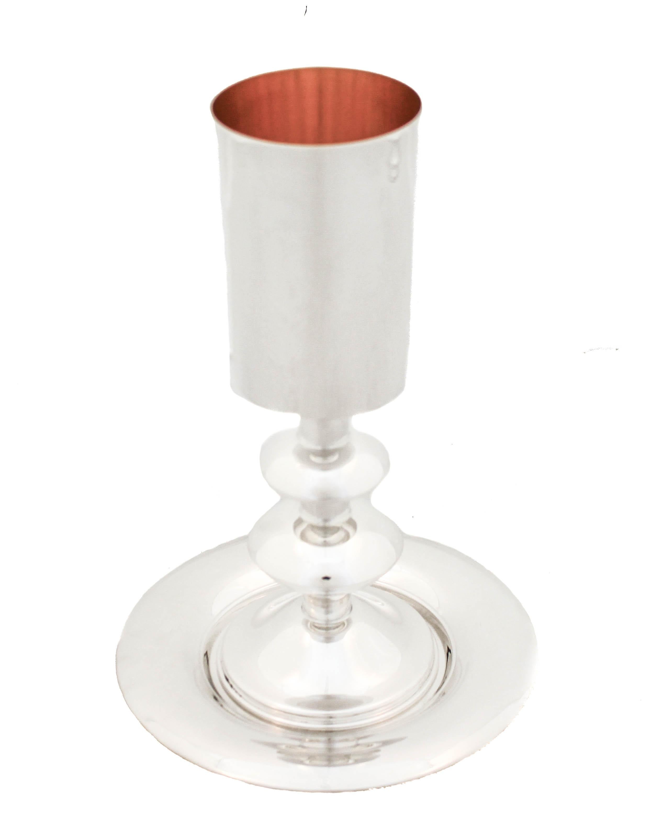 Being offered is a large sterling silver Kiddush Cup & plate.  They design is uber- modern and sleek in both its shape and style.  If you like your sterling (Judaica) on the edgy side this cup and plate are for you.  No etching or anything