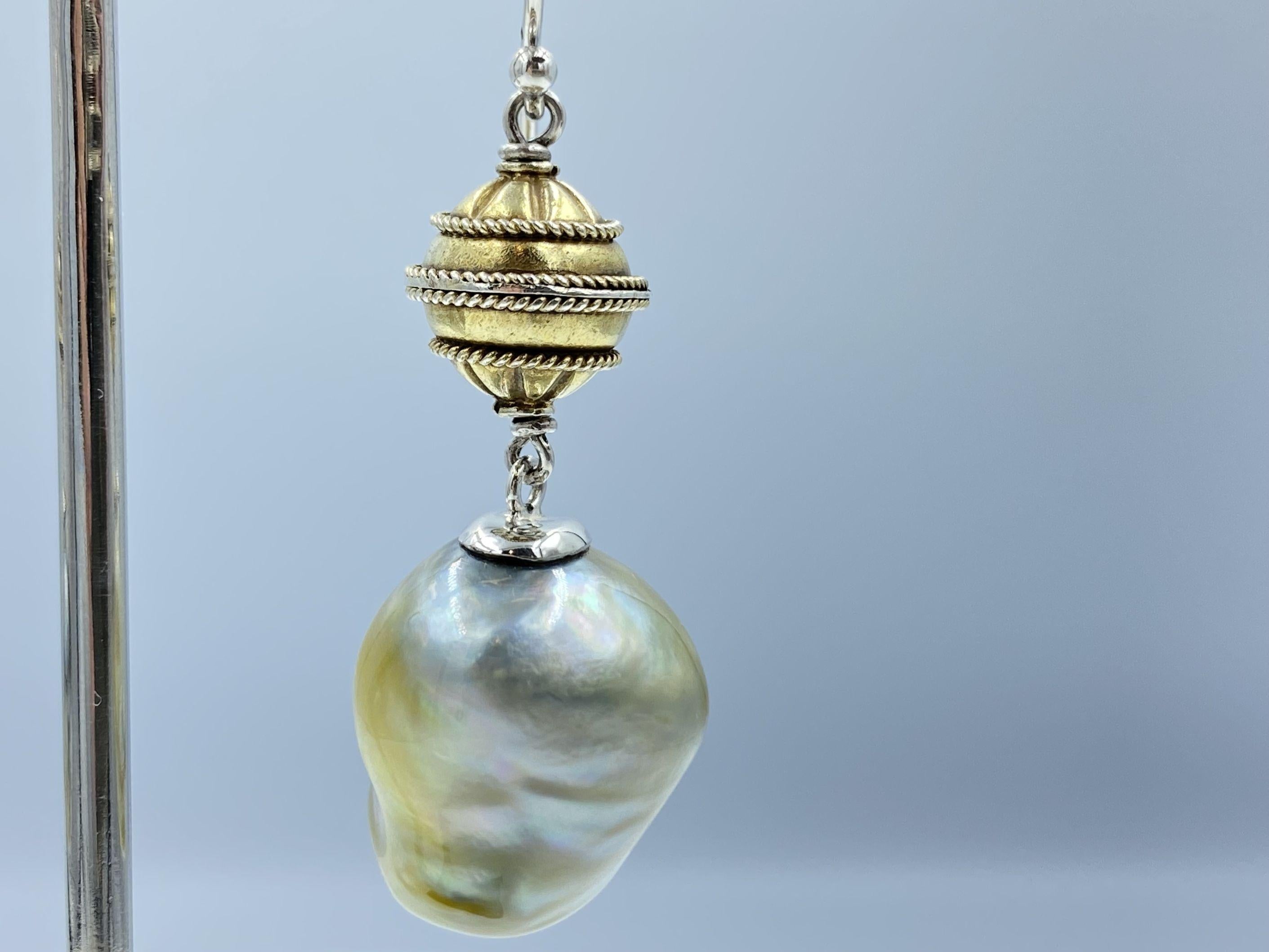 Lustrous, pearlescent baroque south sea pearls finished in Sterling Silver with a gold plated lantern bead, make these drop earrings an unmissable statement piece. Surprisingly light, add style to any outfit in comfort. 

size approx. 5cm long
Pearl