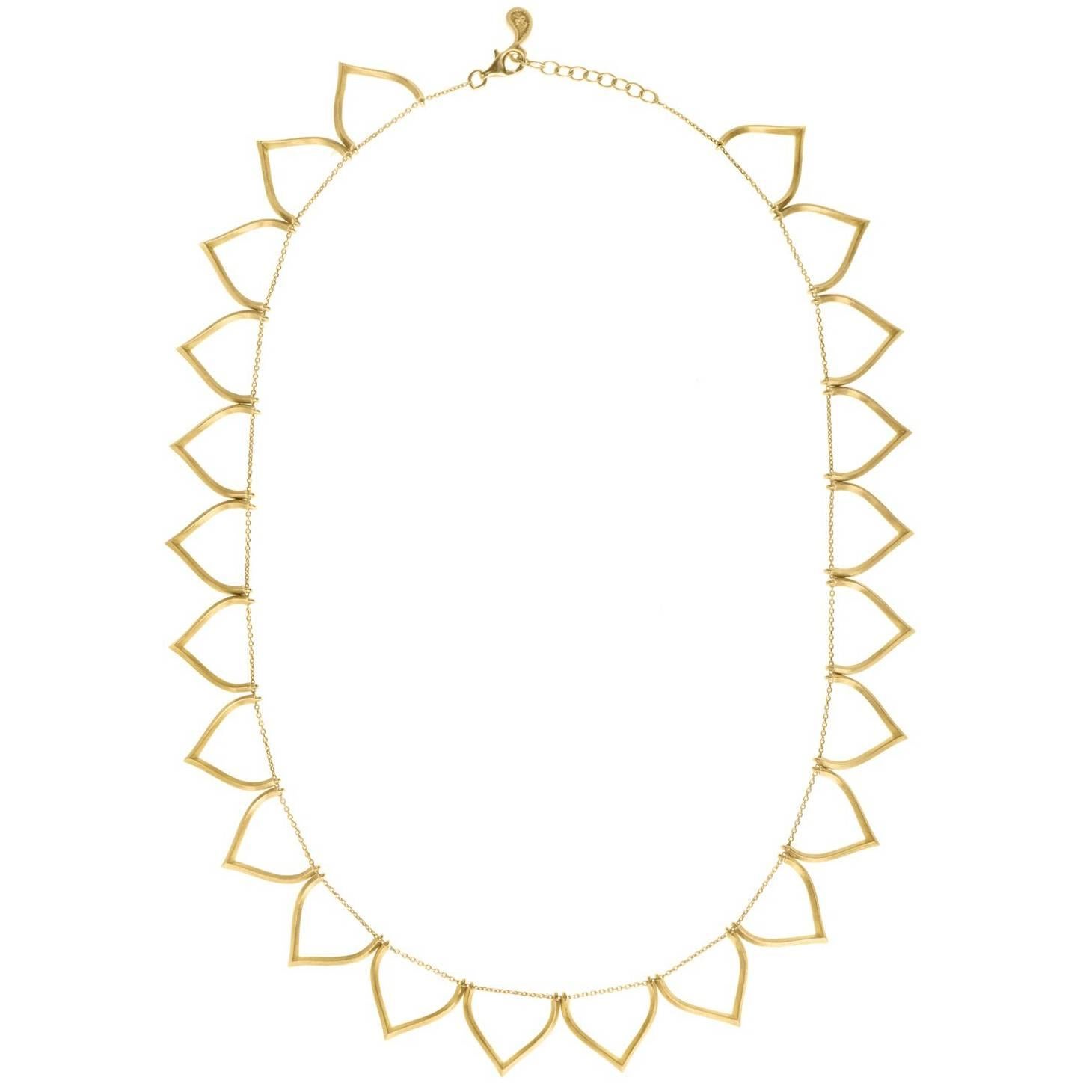 Timeless sterling silver 18k-gold plated necklace featuring lotus shaped motifs that go all around the neck. Every motif has been individually hand-crafted, finished and threaded to the chain by local skilled Greek craftsmen.

This piece is Inspired