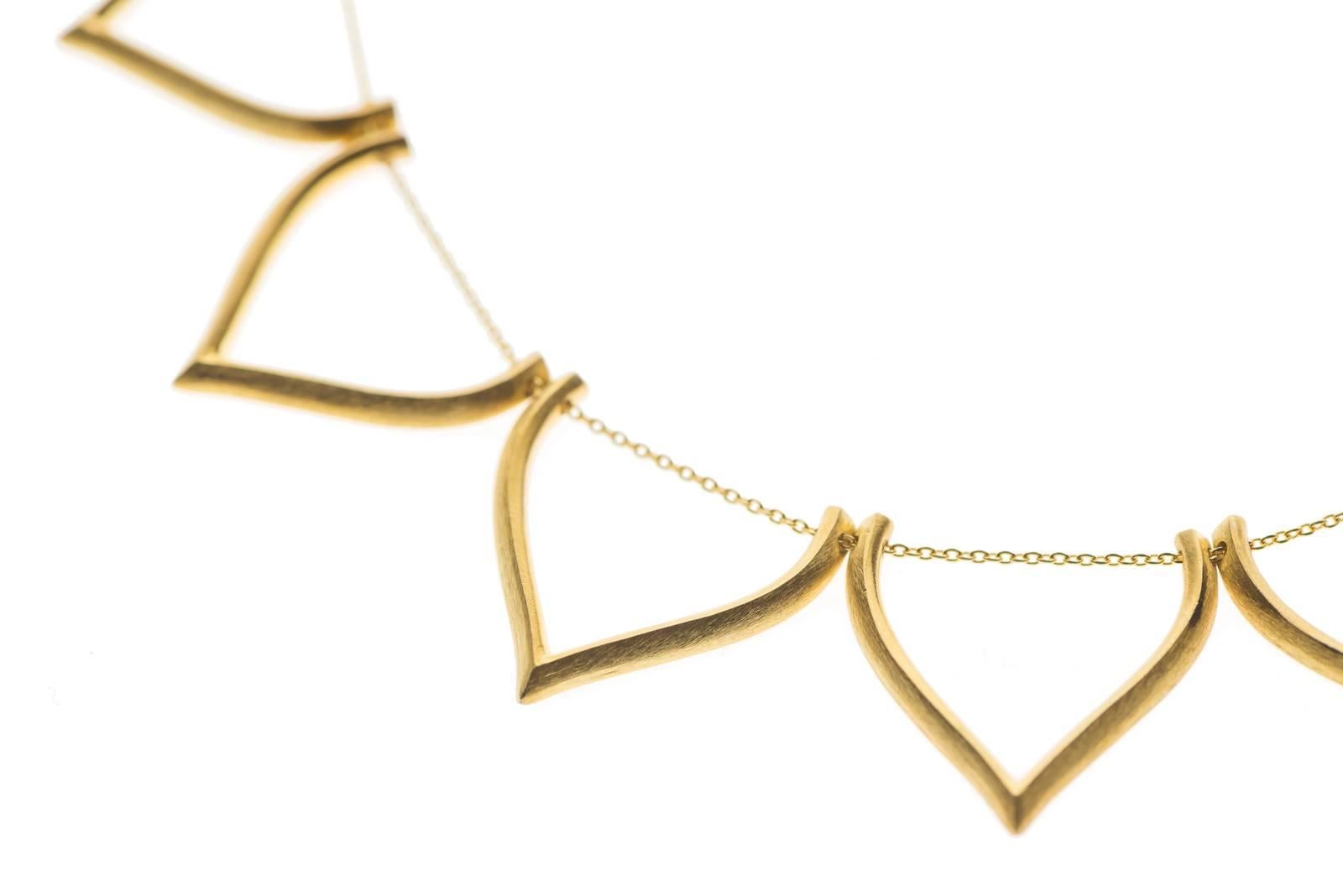  Timeless sterling silver 18k-gold plated necklace featuring lotus shaped motifs with option for enamel coverage. Every motif has been individually hand-crafted, finished and threaded to the chain by local skilled Greek craftsmen.

This piece is