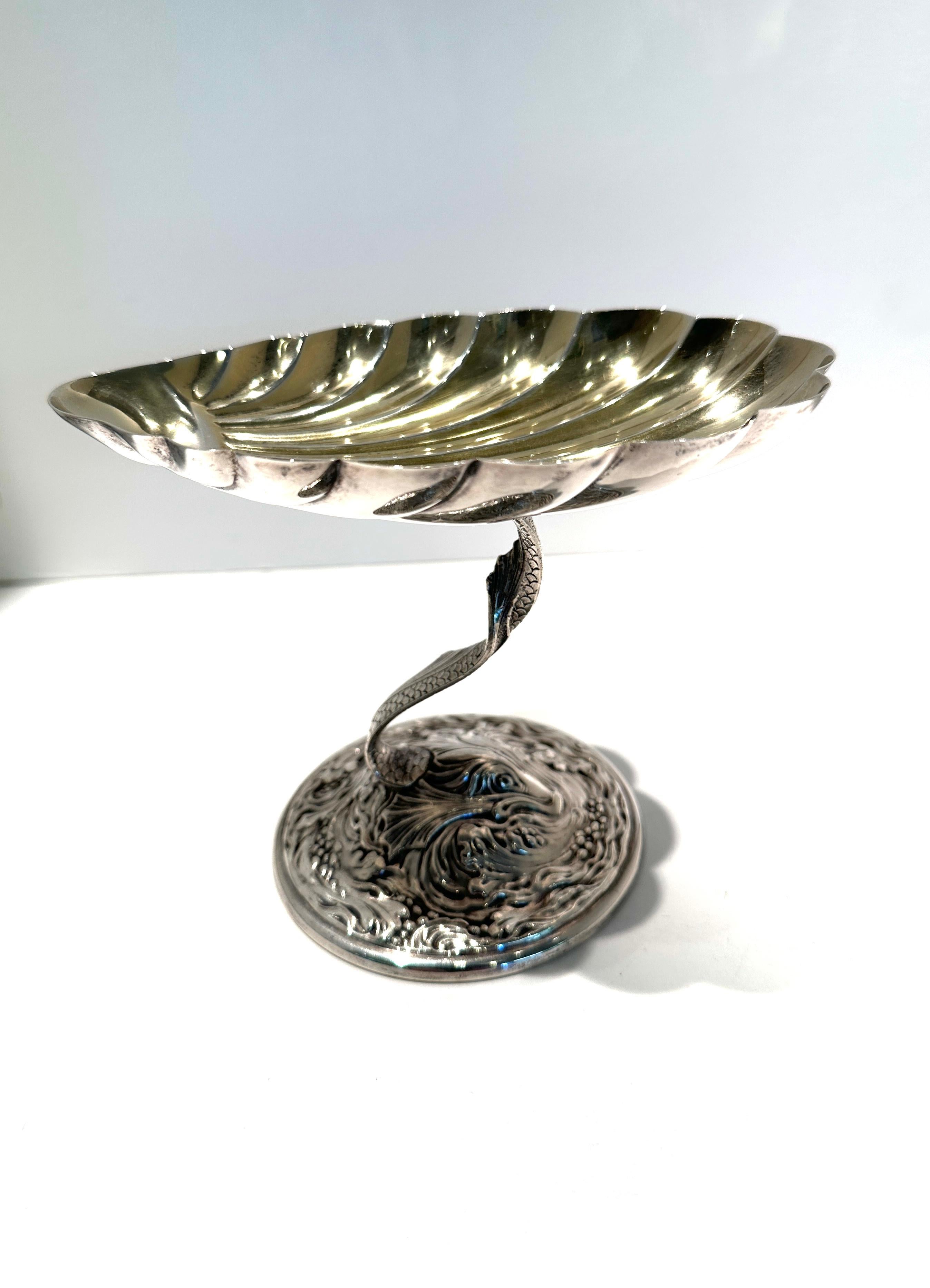 Lovely rare sterling silver dish on stand.  Gold wash shell dish sits on a decorative dolphin base stand.  Rare dish.  made by Gorham in early 1900s.
Excellent condition 