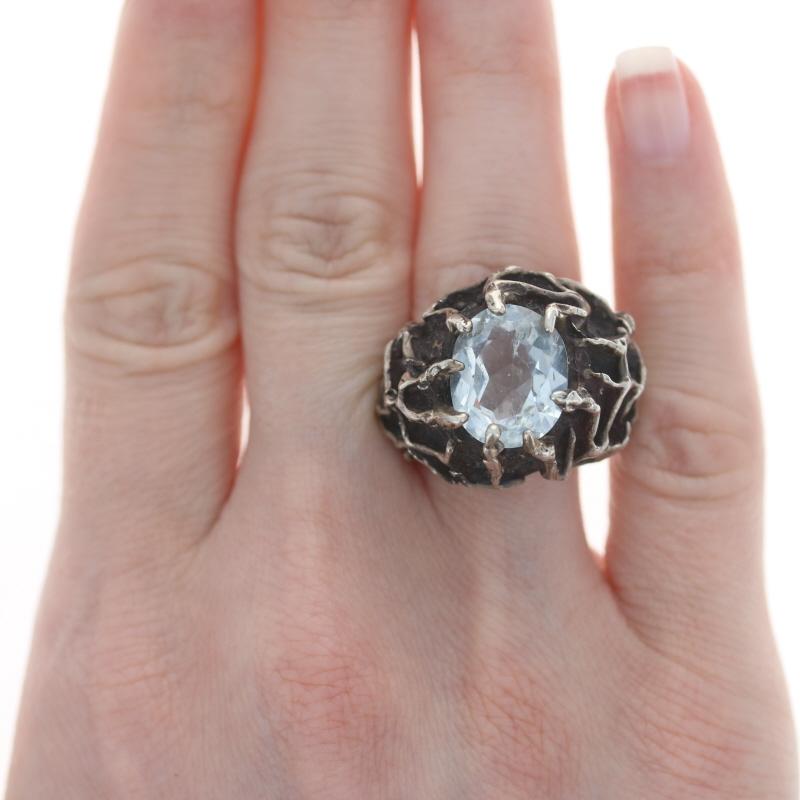 Size: 9

Era: Modernist
Date: 1950s - 1960s

Metal Content: Sterling Silver

Stone Information

Natural Goshenite
Carat(s): 7.80ct
Cut: Oval
Color: Colorless

Total Carats: 7.80ct

Style: Cocktail Solitaire 
Features:  Smooth & textured