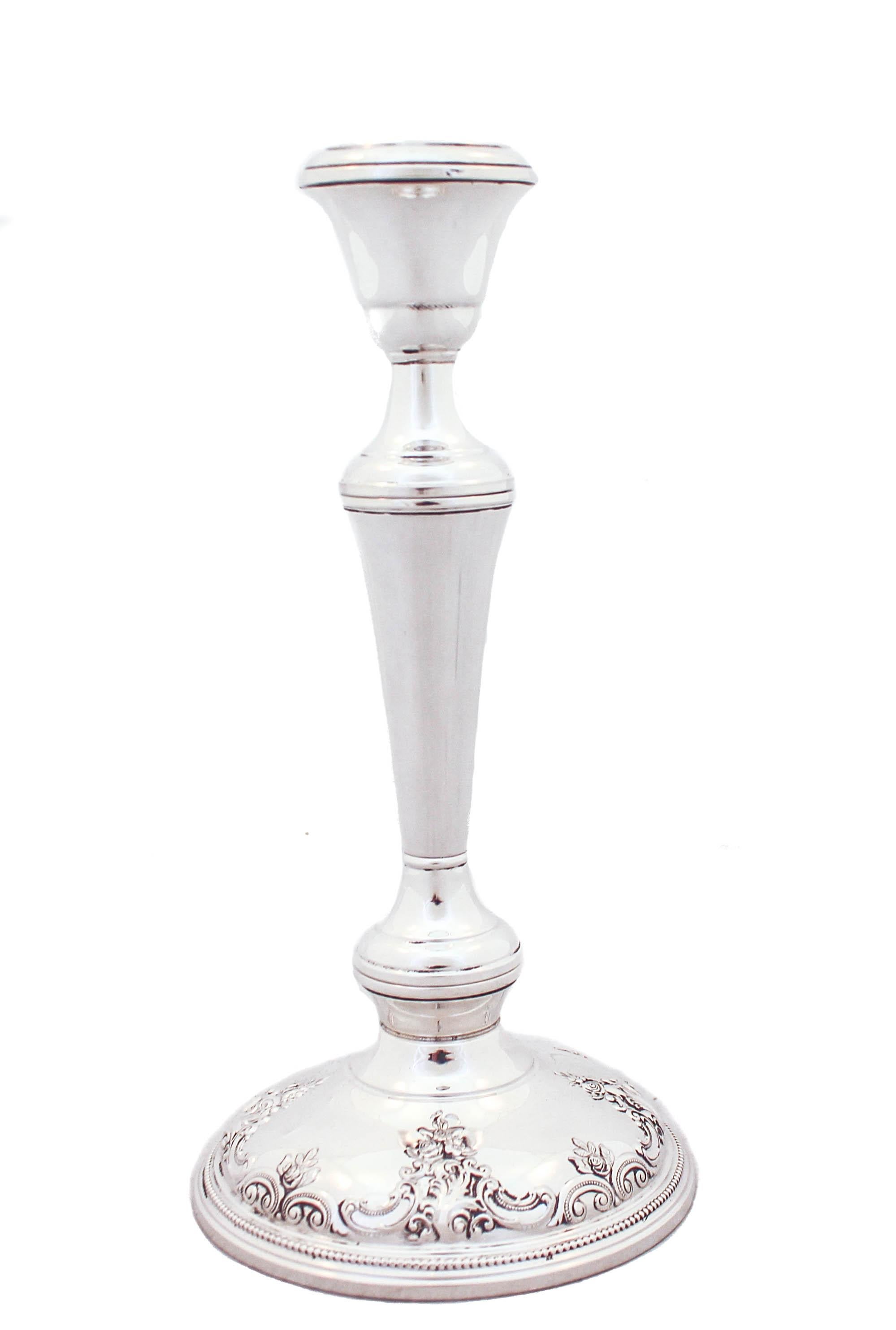 Being offered is a pair of sterling silver candlesticks in the Grande Baroque pattern by Wallace Silversmiths.  Grande Baroque is one of the most famous patterns of all time both in flatware and hollowware.  The elaborate and detailed design is rich