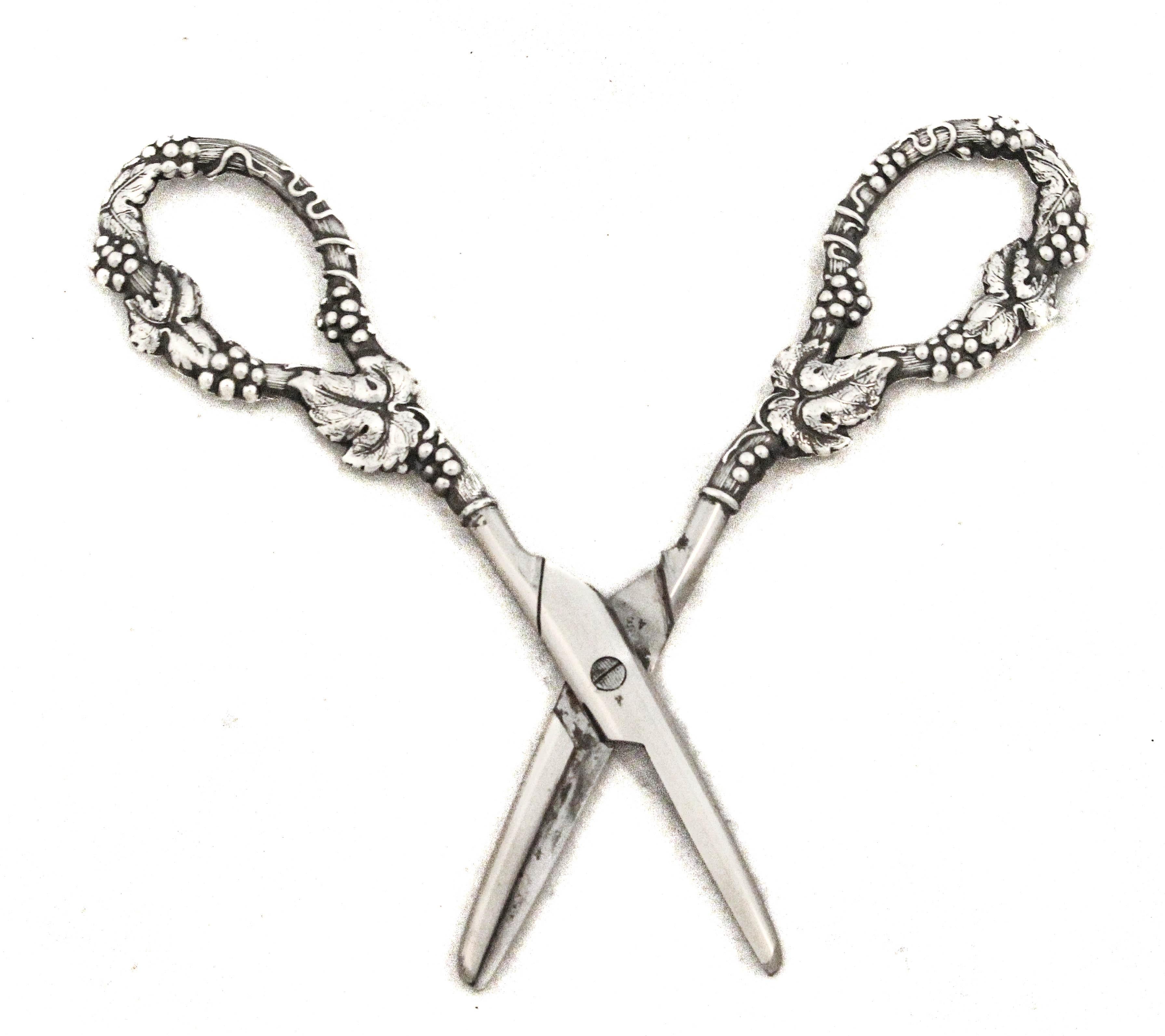 Being offered is a pair of sterling silver grape shears.  They are elegant, specialized utensils designed for delicately cutting grape clusters from their stems at the dining table. Originating in the 19th century, these tools were crafted not only
