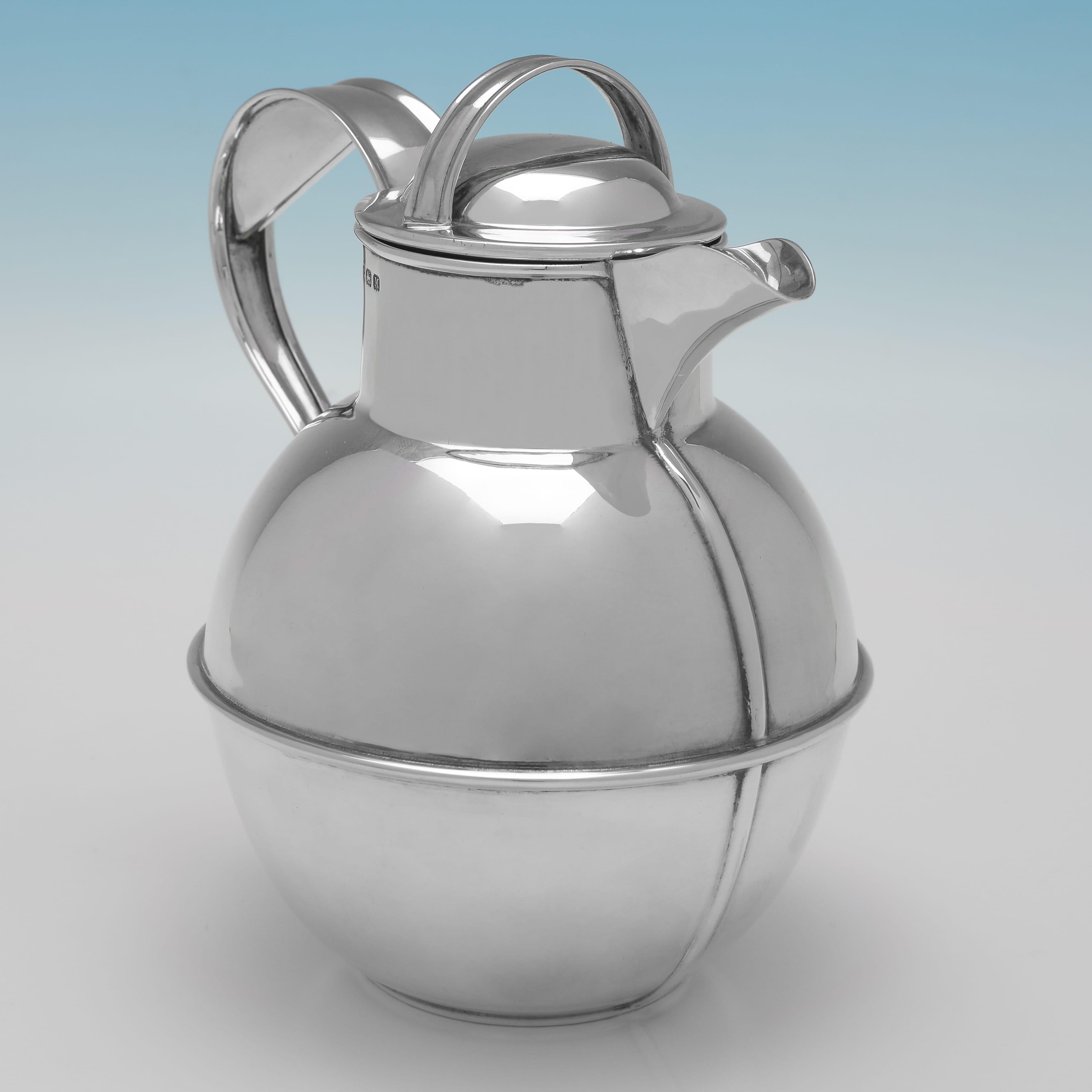 Hallmarked in Birmingham in 1936 by William Holmes, this handsome, Sterling Silver Jug is a handsome replica of the famous Guernsey Milk Jug. The jug measures 6.25