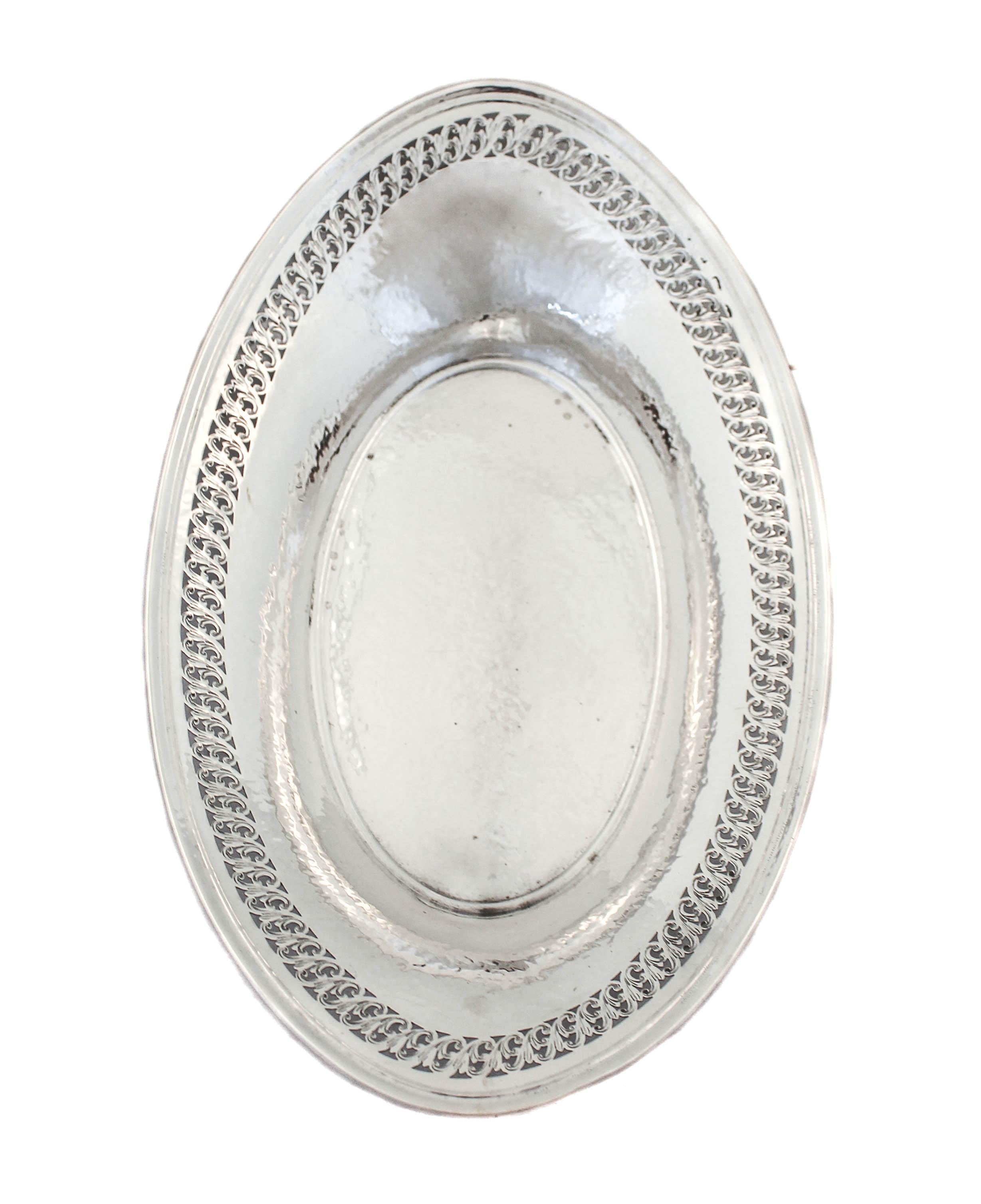 Being offered is a sterling silver breakfast by the Watson Silver Company. Hand hammered with an open-work swirl design around the edge; just enough decoration to give it personality. If you’re not using it for bread on your table, throw some