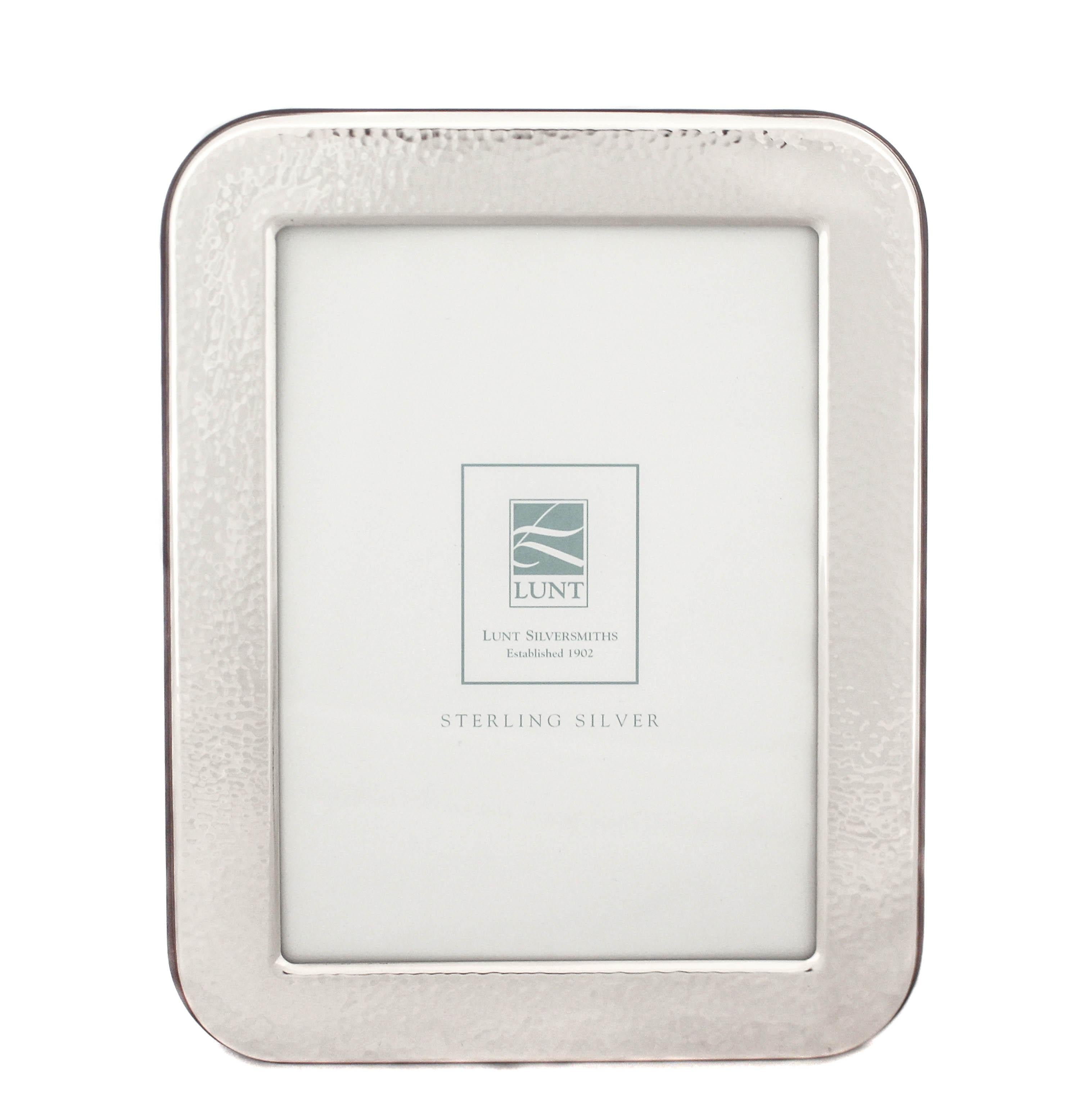 This sterling silver picture frame made by Lunt Silversmiths is new and comes in the original box.  The sterling silver has been coated so it won’t tarnish and the back is lacquer wood for an elegant sleek look.  Excellent quality and design!