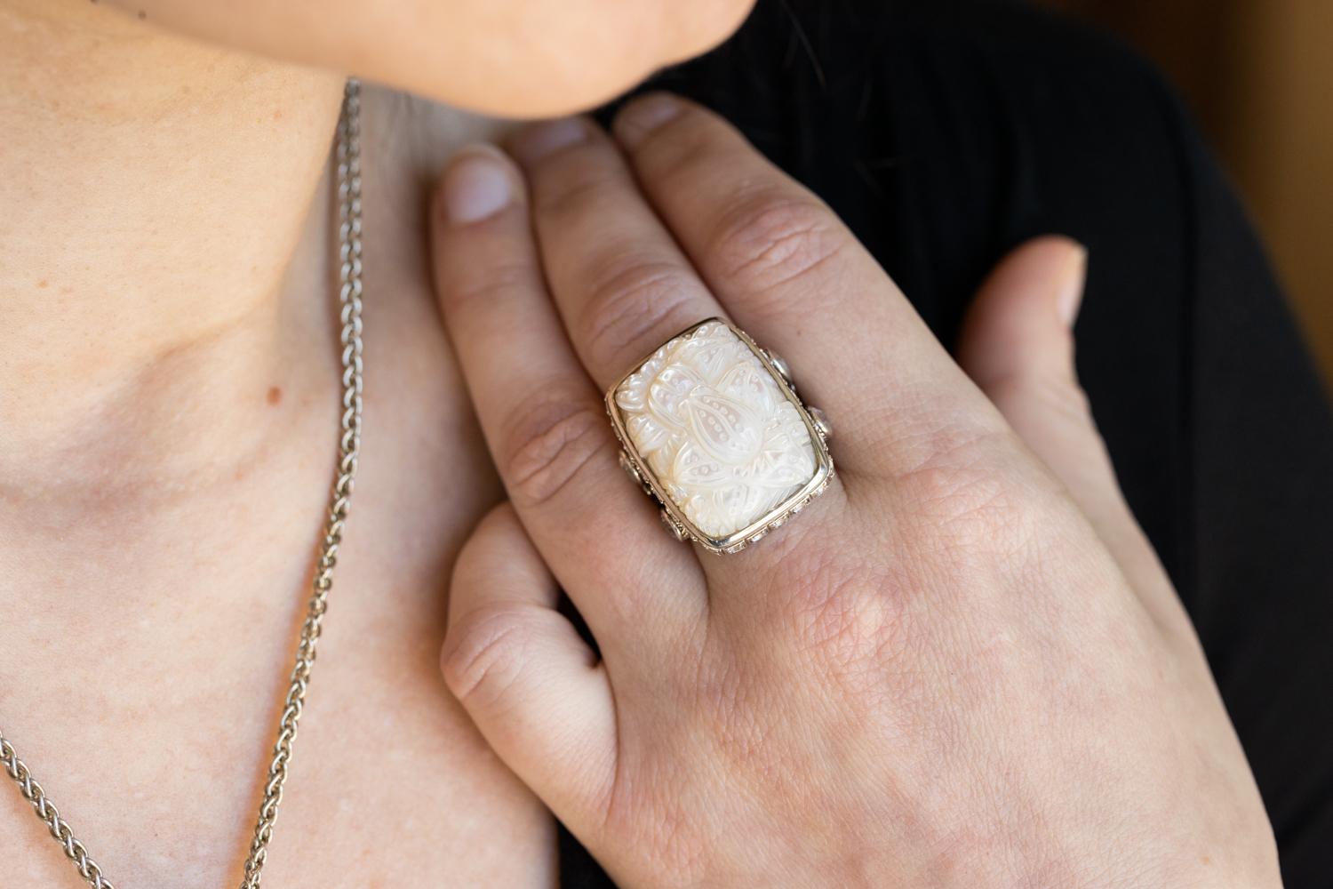 Adorn your hand with the captivating beauty of this Hand Carved Mother of Pearl, Rainbow Moonstone, and Natural Quartz Ring in Sterling Silver. This stunning ring features an intricate blend of gemstones, each carefully selected and expertly carved