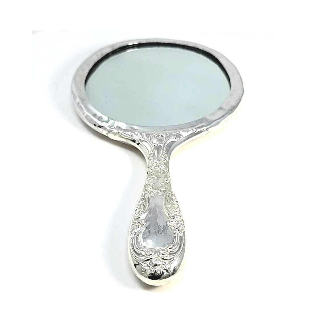 Sterling silver hand mirror with hammered rim.  Engraved handle and back.  Mirror is clean and has minimal wear.