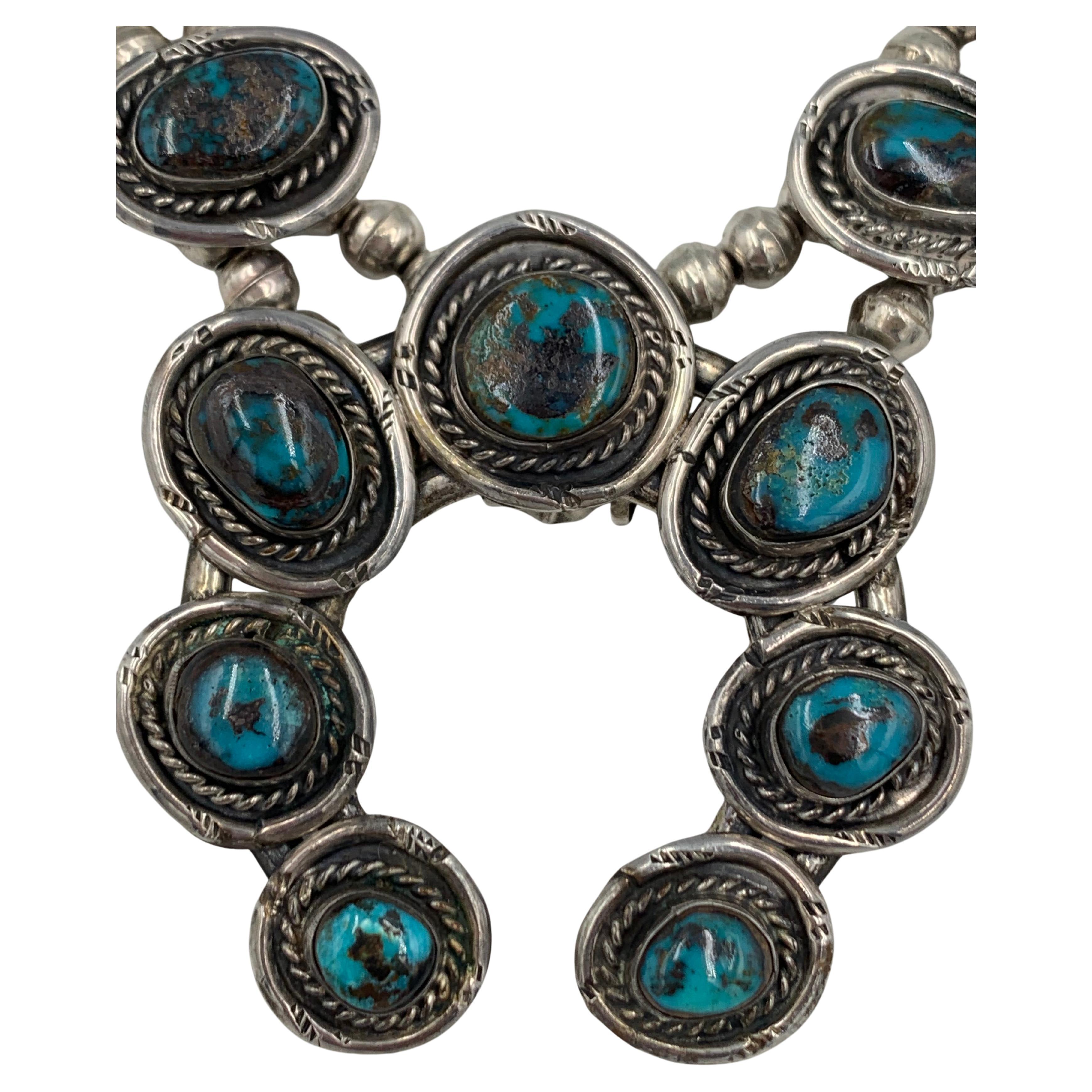 An astonishing seventeen perfectly matched natural Bisbee turquoise cabochons were used to create this super rare squash blossom necklace. Today, due to the scarcity of the turquoise the necklace would not be able to be made. Each of the large