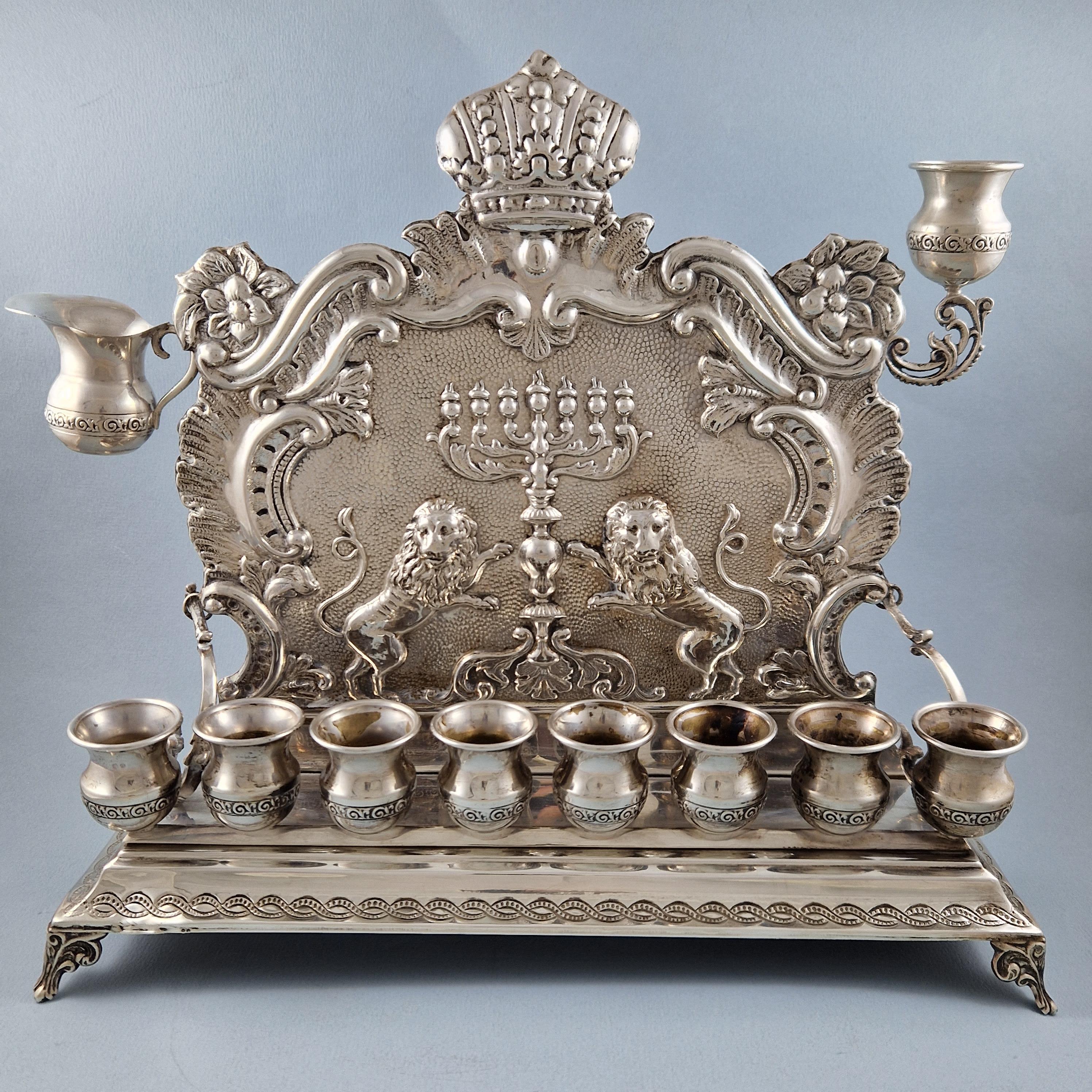 Sterling silver Hanukkah lamp 

925 silver hallmark 

Length: 30.7 cm 
Width: 9.7 cm 
Height: 27.8 cm 
Weight: 755 grams

Good condition, just one nut is missing.