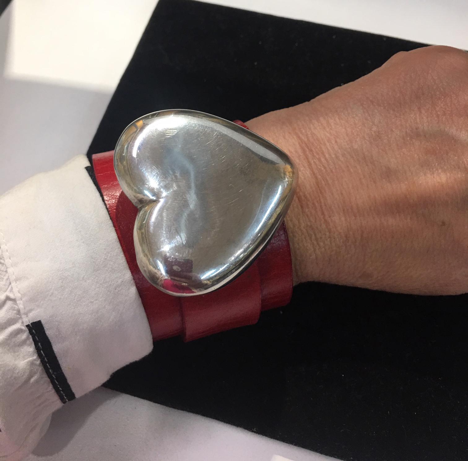 Add pizzazz to any look with this beautiful heirloom leather cuff. This Retro puffy sterling silver heart, circa: 1940s, featured here on a red genuine leather cuff.  You can slide it off the cuff and wear it as a pendant.  A unique addition to any