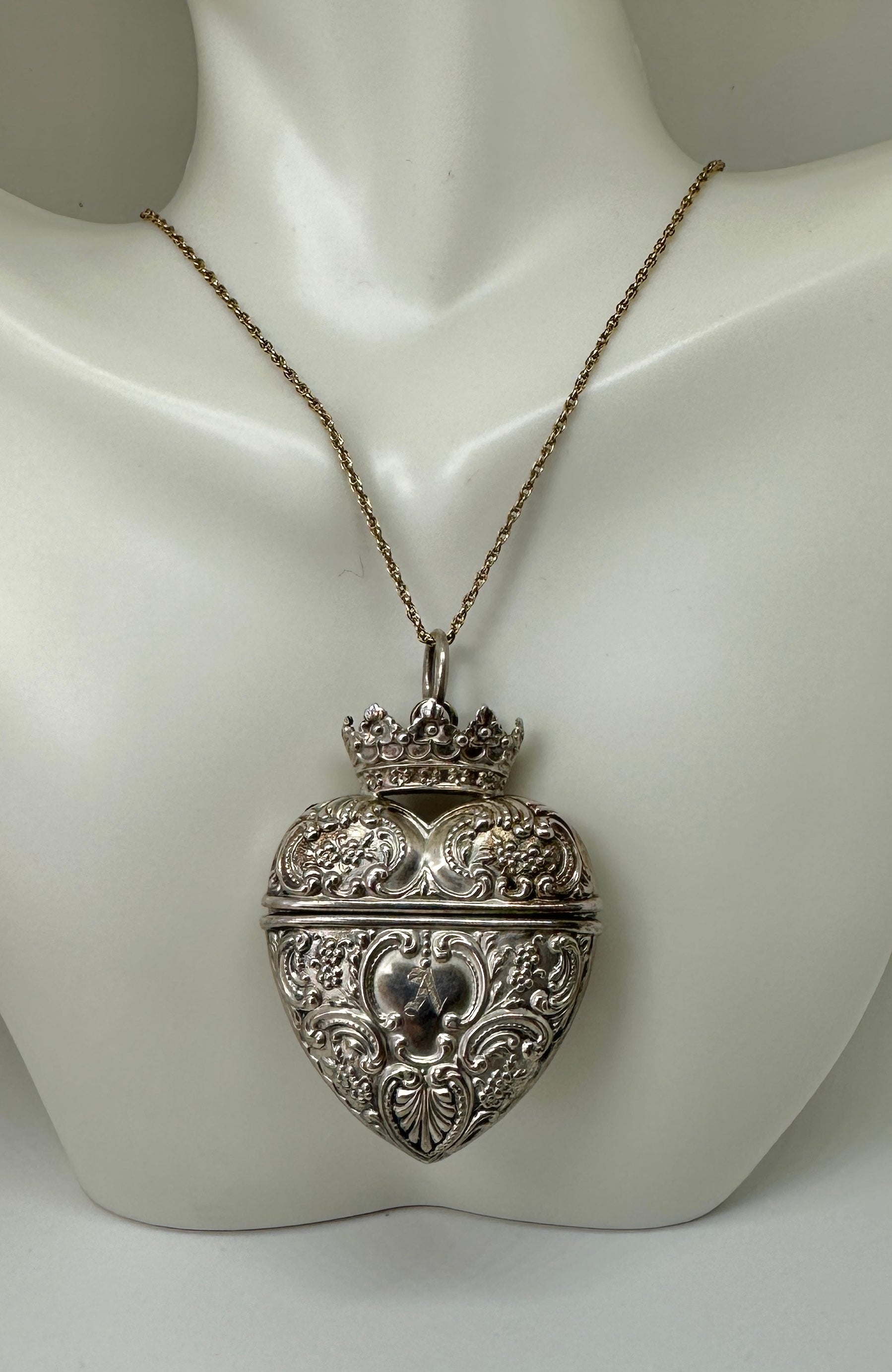 THIS IS A WONDERFUL ANTIQUE VICTORIAN HEART SHAPE LOCKET OR PERFUME VINAIGRETTE BY THE ESTEEMED AMERICAN SILVERSMITH FOSTER & BAILEY.
THE SILVER LOCKET PENDANT IS IN THE FORM OF A HEART.  IT HAS BEAUTIFUL ACANTHUS LEAF SCROLL MOTIF AND FLOWER MOTIF