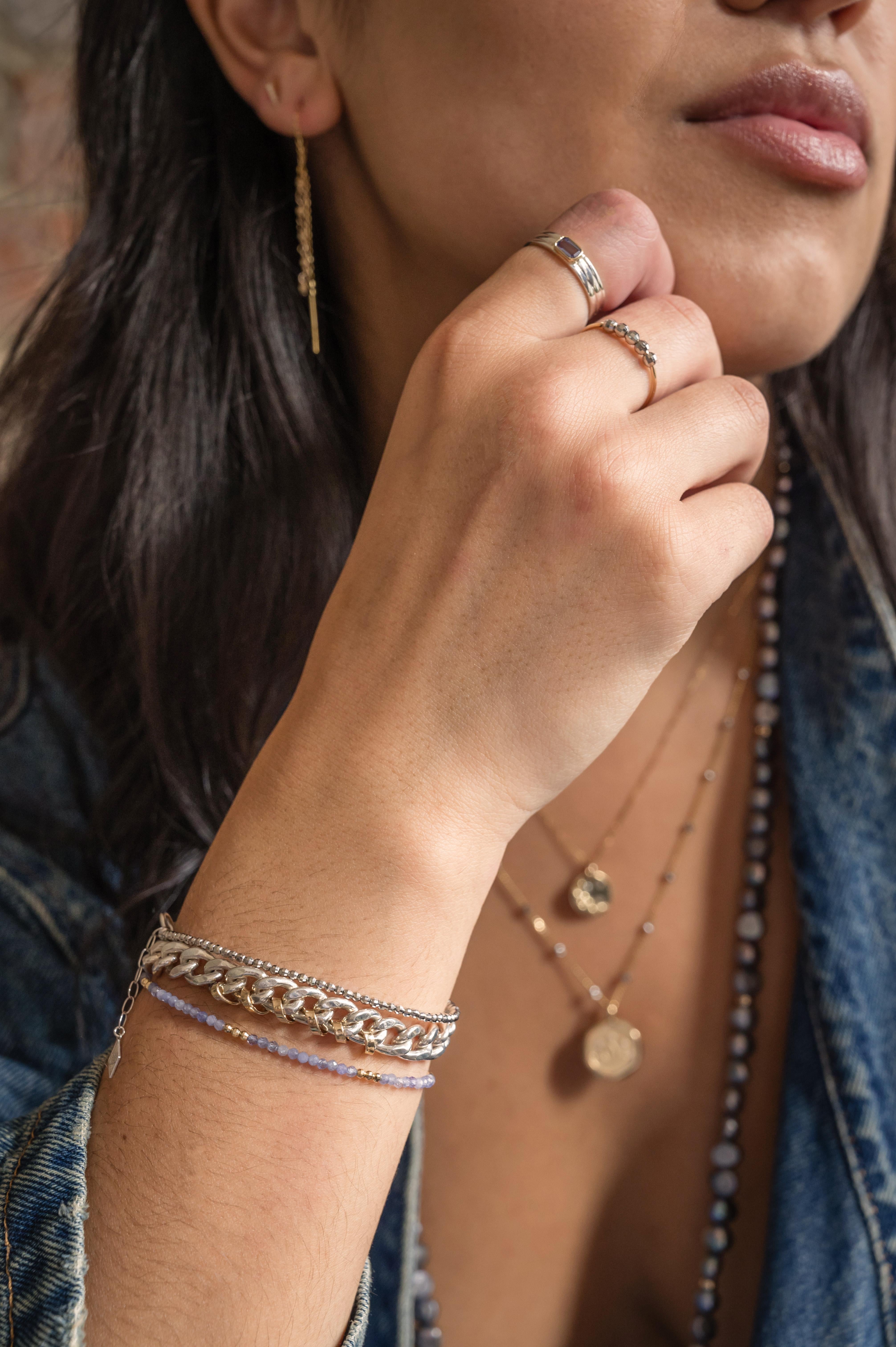 This bracelet is bold and edgy and we thing pretty much perfect with the added sophistication of 14K Gold hand wire-wrapped detail and a two part 14K gold lobster clasp.  Great by itself and also great for layering.  

Elliot Young Fine