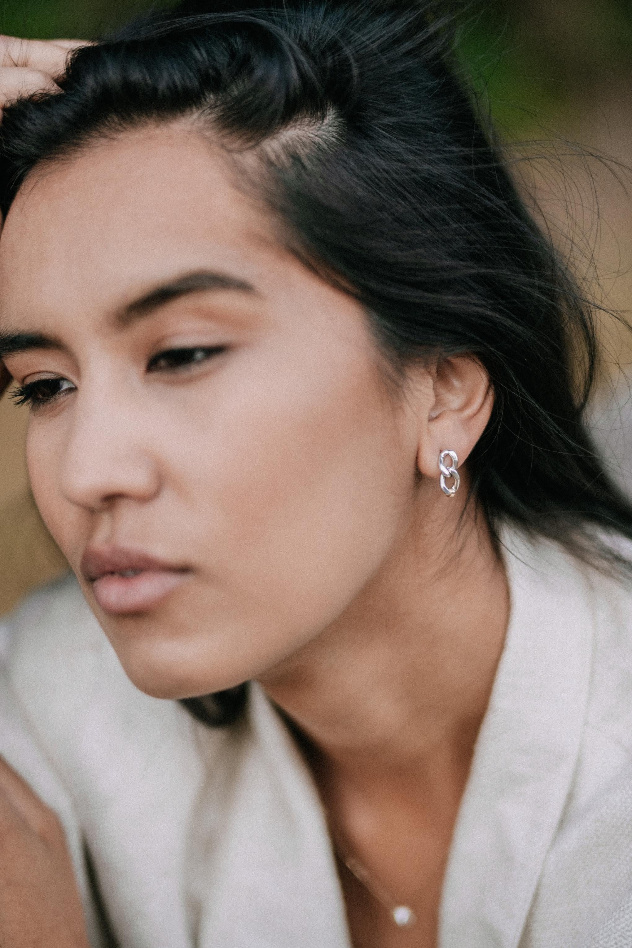 Bold but also easy to wear--the perfect Sterling chain post earrings with the added sophistication of 14K Gold hand wire-wrapped detail are calling for your jewelry box.  Has a matching Bracelet and Choker.

Elliot Young Fine