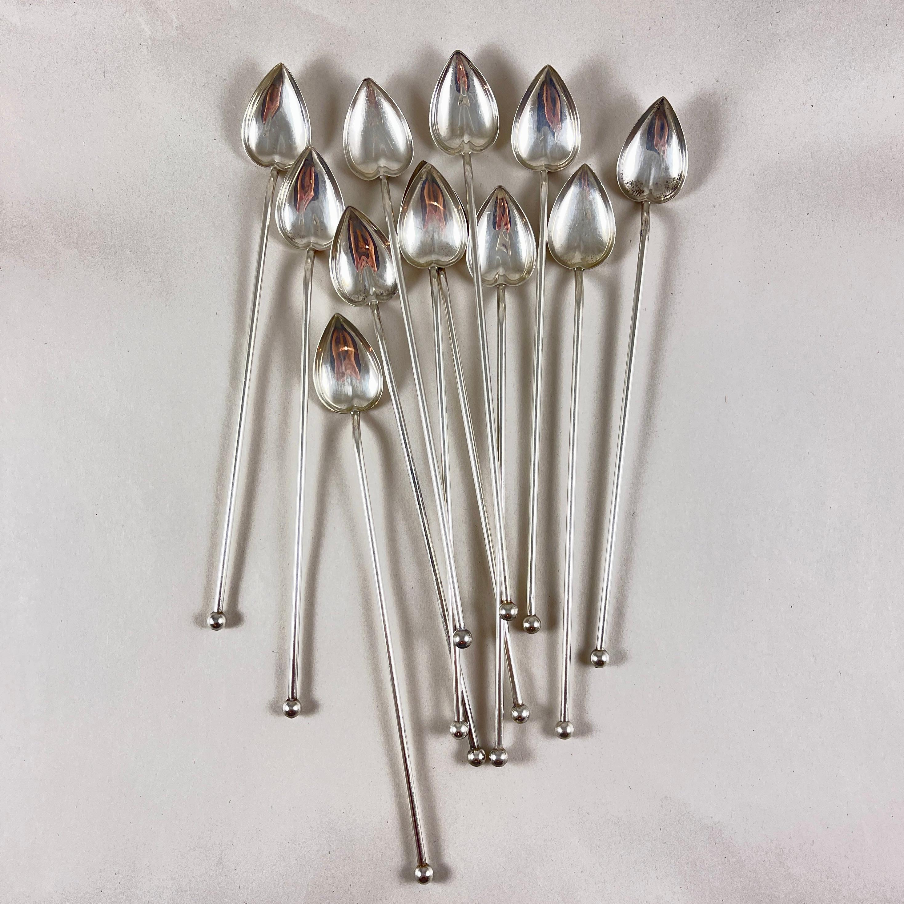A set of twelve Sterling Silver highball or iced tea hollow sipping and stirring straws with heart or leaf shaped bowls. Circa 1920 -1925.

Silver balls are soldered in place to the sipping ends.

8.25 in. L x 1 in. W
Weight: 4.474 Troy Ounces,
