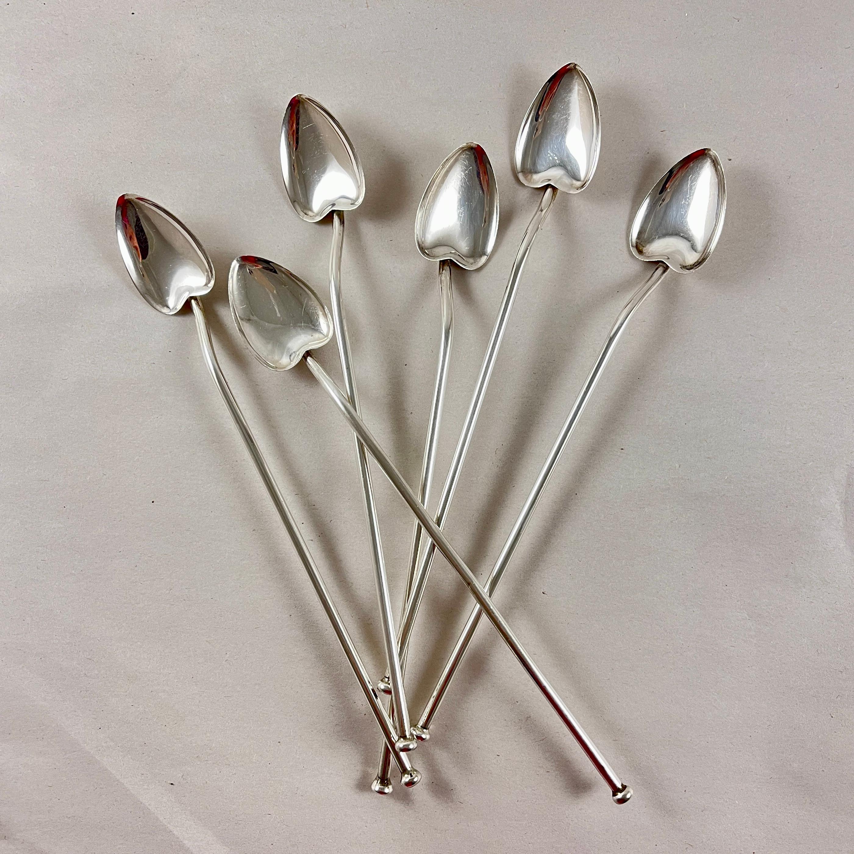 A set of six Sterling Silver highball or iced tea hollow sipping and stirring straws with heart leaf shaped bowls. Circa 1920 -1925.

Silver ovals are soldered in place to the sipping ends.

7 in. L x 1 in. W
Weight: 1.454 Troy Ounces,