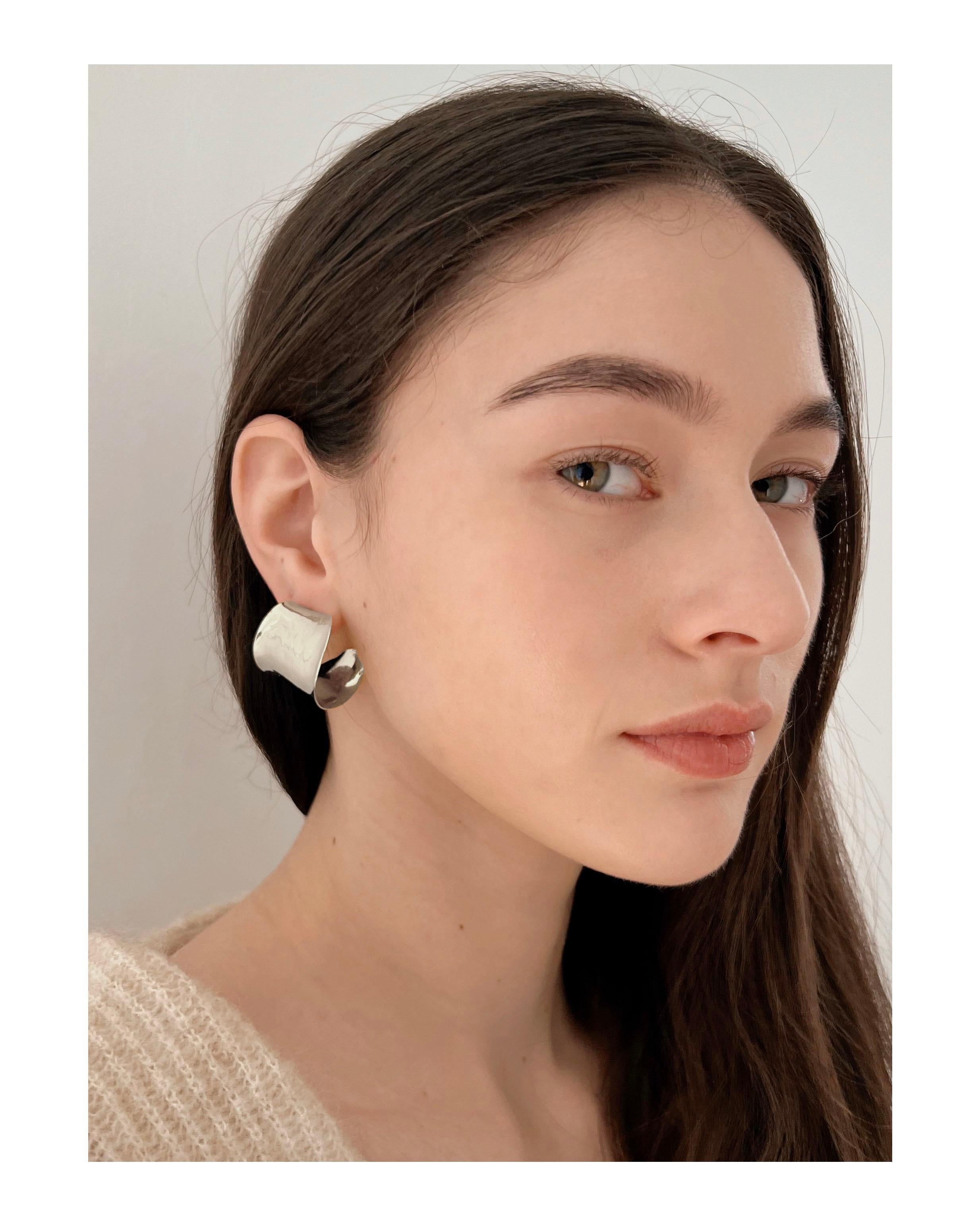 Fay Andrada's Hilma Hoops are a modern, sculptural take on a classic earring. With subtle curves and hand finishing these hoops suit special occasions and every day wear. 

The earrings are cast by hand, in recycled sterling silver. The finish is a