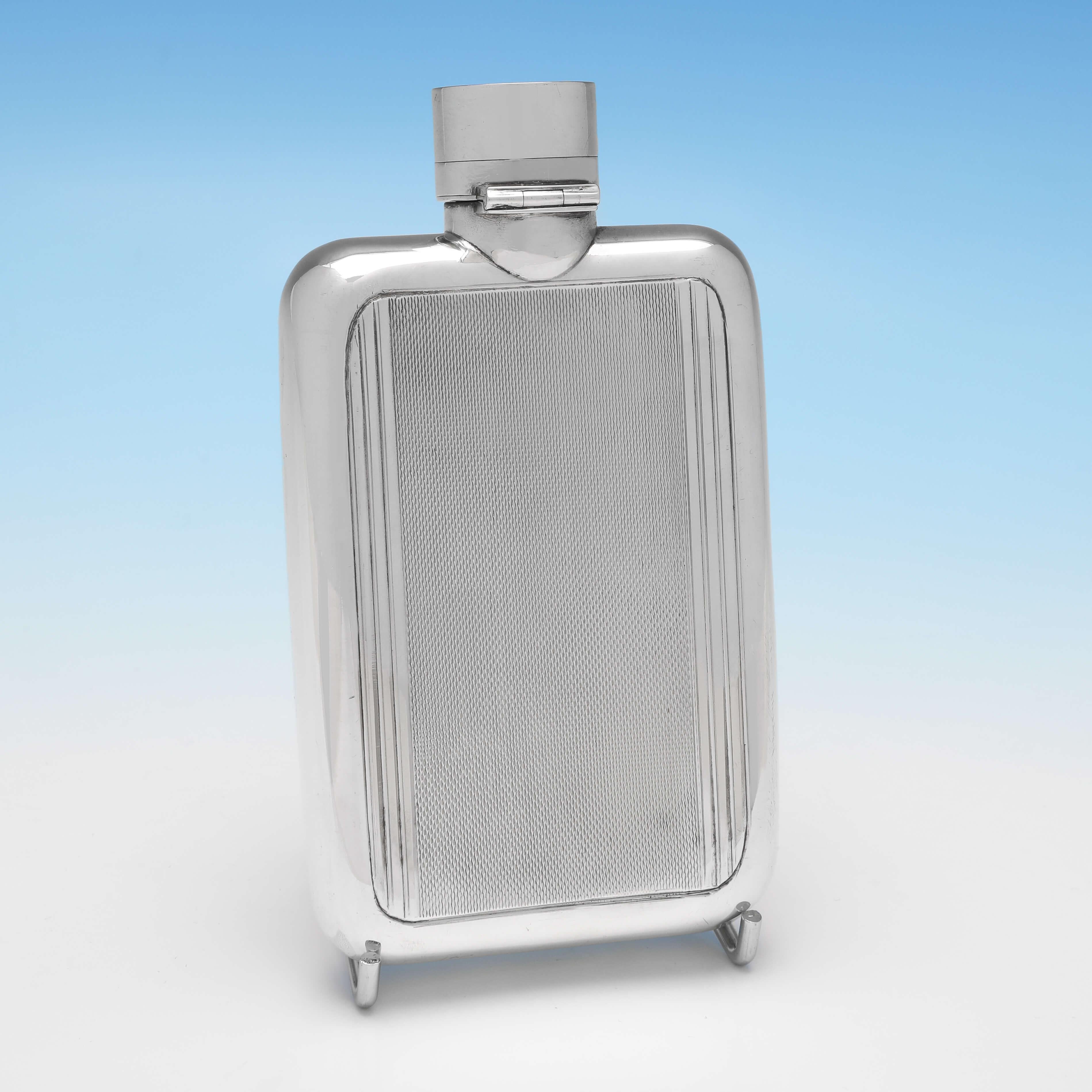 Hallmarked in London in 1947 by Mappin & Webb, this very handsome, Sterling Silver hip flask, is in the Art Deco taste, and features engine turned engraving and a bayonet cap. The hip flask measures 5.25