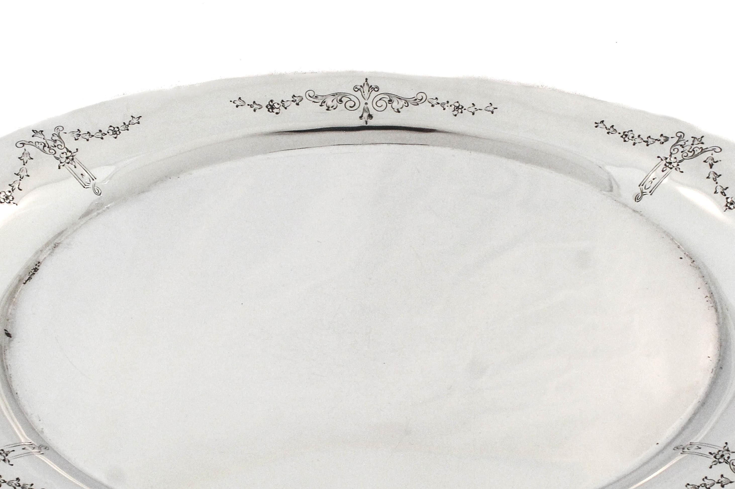 This is a beautifully crafted sterling silver oval platter by International Silver, showcasing timeless elegance and refined detail. The center of the platter is completely flat, making it ideal for serving everything from carved meats to hors
