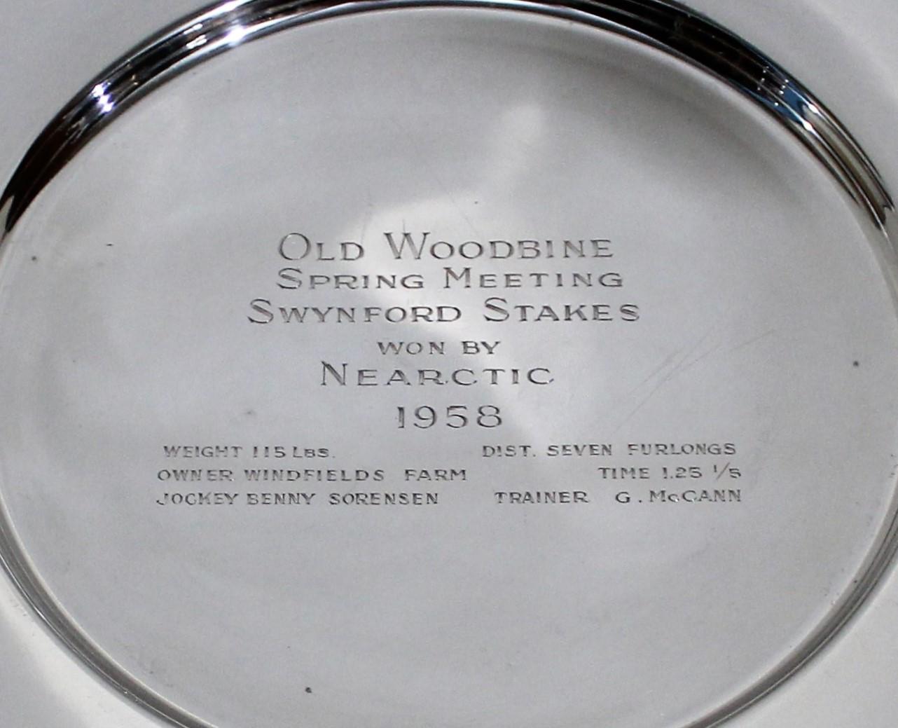 Sterling Silver Woodbine trophy plate. E. P. Taylor owned 'Neartic' Woodbine trophy from the Ontario Jockey Club.
 
The trophy reads:

Old Woodbine
Spring Meeting
Swynford Stakes
won by
Nearctic
1958

weight 115lbs dist. seven