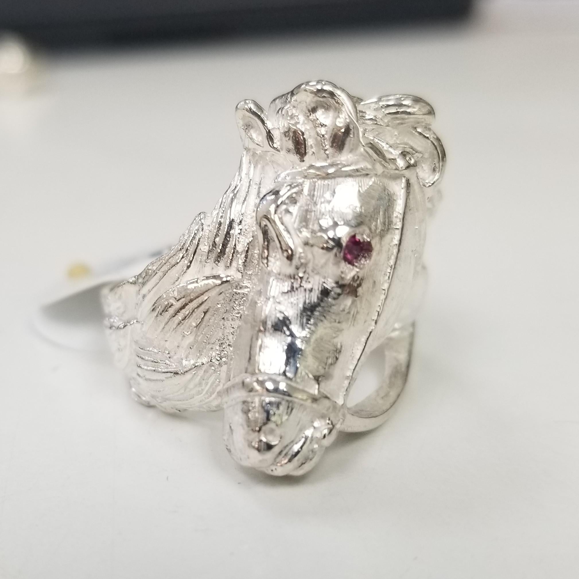 Sterling Silver horse ring with a ruby eye, containing 1 round ruby weighing .04pts. ring size is 9 and can be size to fit for free. weighing 10 grams