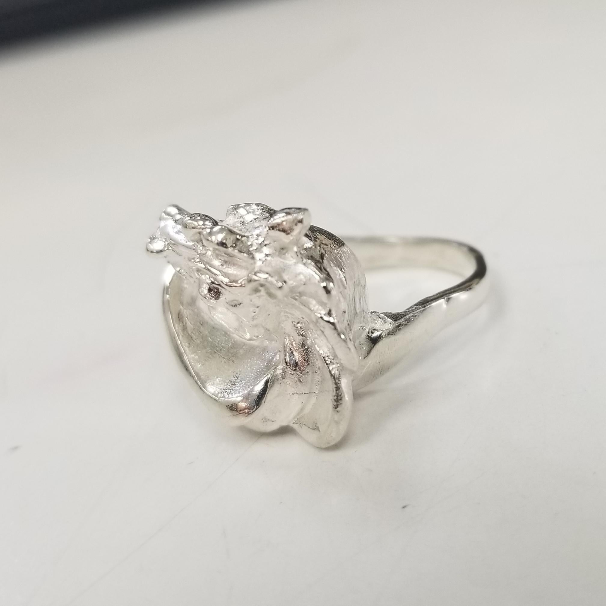 Sterling Silver horse ring with a ruby eye, containing 1 round ruby weighing .04pts. ring size is 9 and can be size to fit for free. weighing 11 grams