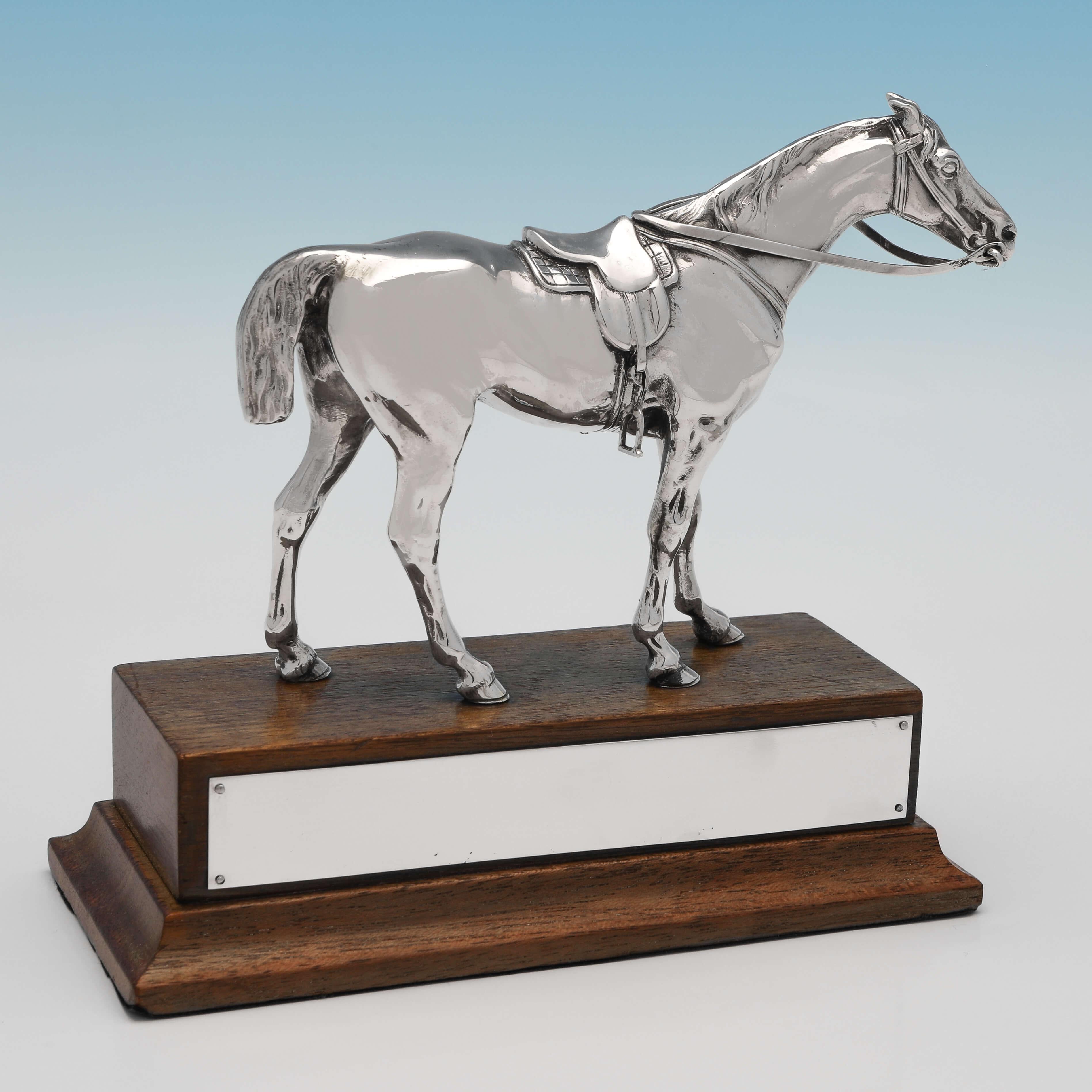 Carrying import marks for London in 1954 by C. J. Vander, this handsome, Sterling Silver Model of a Horse, stands on a wooden plinth with a vacant plaque, and has been realistically modelled. The horse trophy measures 5.75